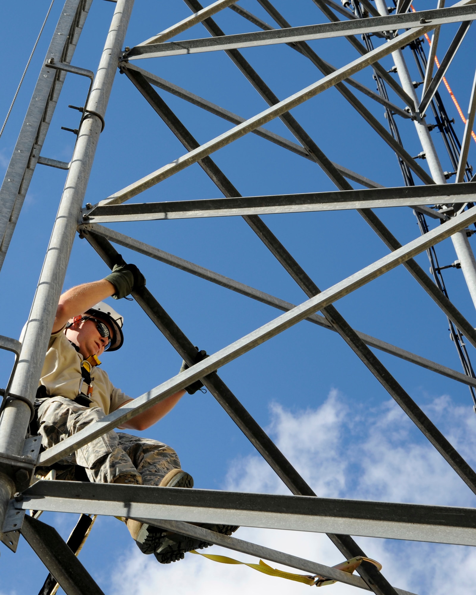Staff Sgt. John Hines, 2nd Communications Squadron cable and antenna systems, climbs a communication tower on Barksdale Air Force Base, La., Nov. 19, 2014. The Cable Dawgs Airmen specialize in copper and fiber optic cabling; connecting all telephones and computer systems on base. (U.S. Air Force photo/ Senior Airman Jannelle Dickey)