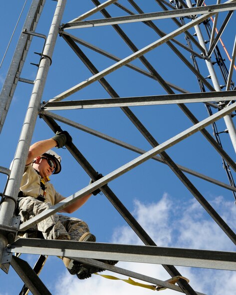 Staff Sgt. John Hines, 2nd Communications Squadron cable and antenna systems, climbs a communication tower on Barksdale Air Force Base, La., Nov. 19, 2014. The Cable Dawgs Airmen specialize in copper and fiber optic cabling; connecting all telephones and computer systems on base. (U.S. Air Force photo/ Senior Airman Jannelle Dickey)