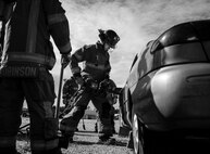 A 96th Test Wing firefighter uses a prying tool to open the car door during an extraction training exercise at Duke Field, Fla., Sept. 10.  The day crew of Fire Station 4 took part in the exercise to meet their training requirement.  National Fire Prevention Week began Oct. 5.  Eglin firefighters have various activities planned throughout the week.   (U.S. Air Force photo/Tech. Sgt. Sam King)
