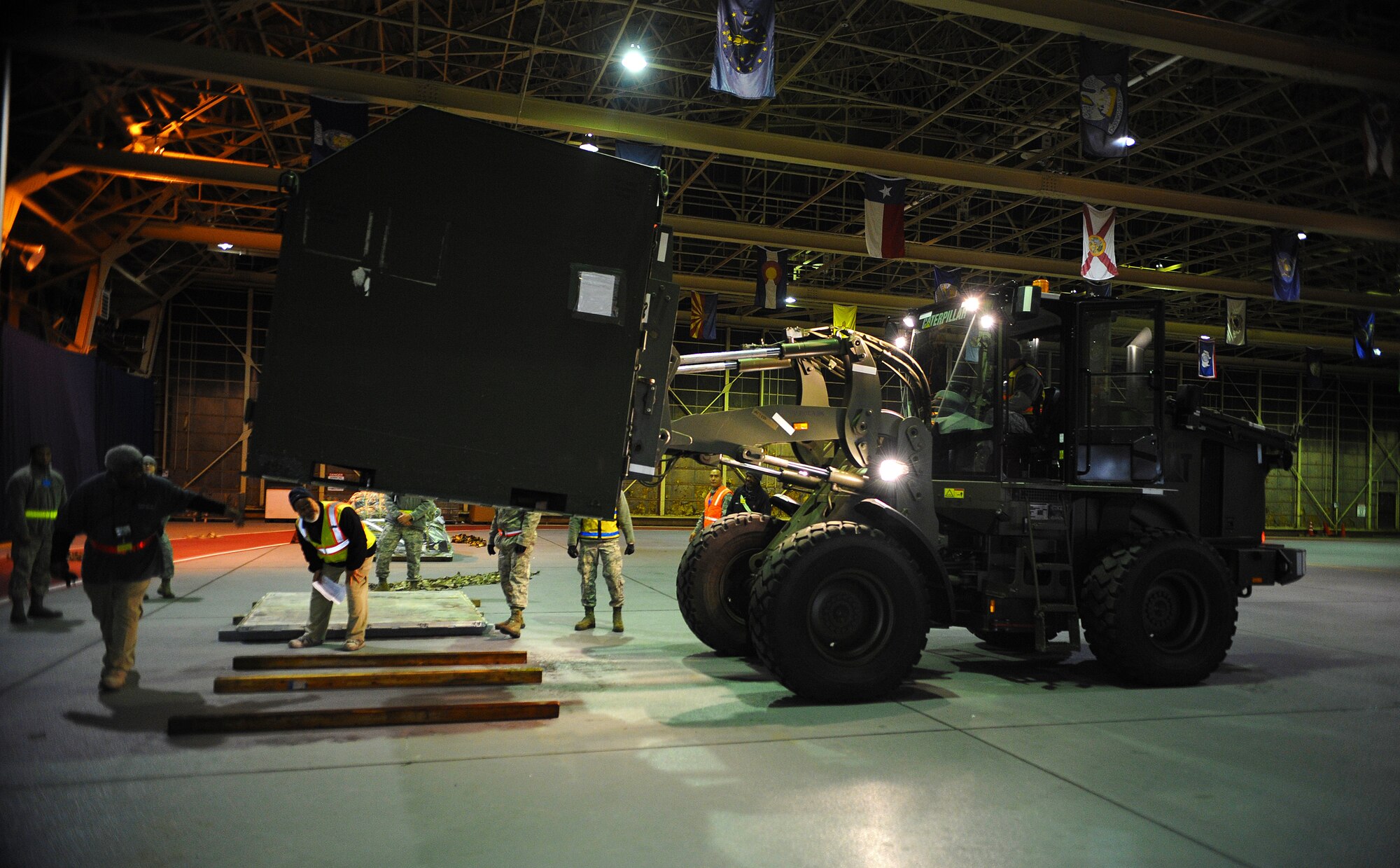 Airmen inspect cargo before loading it onto an aircraft during exercise Beverly Sunrise 15-1 at Misawa Air Base, Japan, Dec. 3, 2014. Beverly Sunrise 15-1 initiated a new way of exercising to implement more effective ways to execute the 35th Fighter Wing mission. (U.S. Air Force photo by Airman 1st Class Jordyn Rucker/Released)