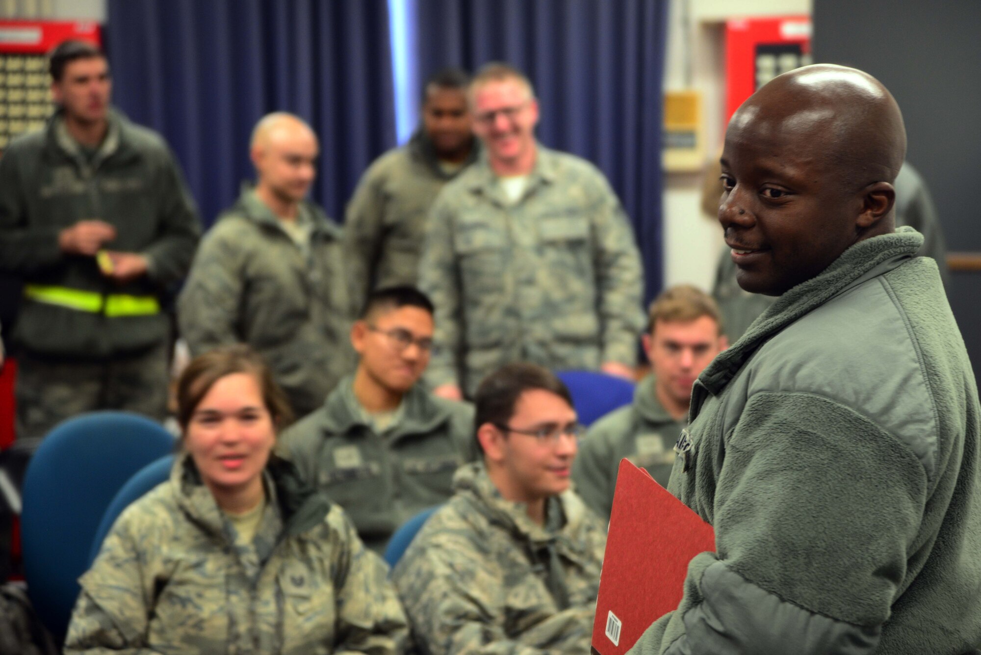 Airmen from the 35th Fighter Wing wait to be briefed Dec. 4, 2014, in the first stages of a Personnel Deployment Function line at Misawa Air Base, Japan. Approximately 200 Airmen deployed as part of Beverly Sunrise 15-1, an exercise that included multiple bases across Pacific Air Forces. (U.S. Air Force photo by Staff Sgt. Derek VanHorn/Released) 