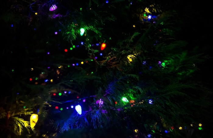 Colorful lights glow on the Joint Base Charleston – Air Base Christmas tree during the holiday tree lighting ceremony Dec. 3, 2014, at JB Charleston, S.C. Airmen, Sailors, civilians, families and friends gathered around the tree to sing carols, enjoy cookies, drink hot chocolate and to meet Santa Claus. (U.S. Air Force photo/Senior Airman Jared Trimarchi) 