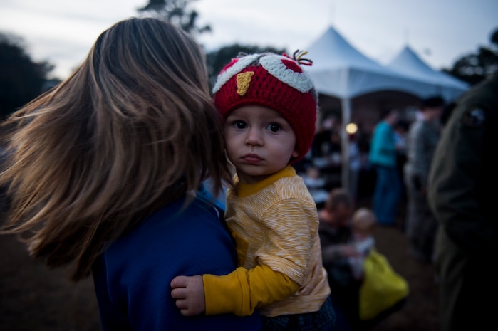 Redick Johnson, son of Kendall and Haleigh Johnson, shows off his holiday hat during a Christmas tree lighting ceremony Dec. 3, 2014, at Joint Base Charleston, S.C. Airmen, Sailors, civilians, families and friends gathered around the tree to sing carols, enjoy cookies, drink hot chocolate and to meet Santa Claus. Kendall  is a member of the 437th Aerial Port Squadron. (U.S. Air Force photo/Senior Airman Jared Trimarchi) 