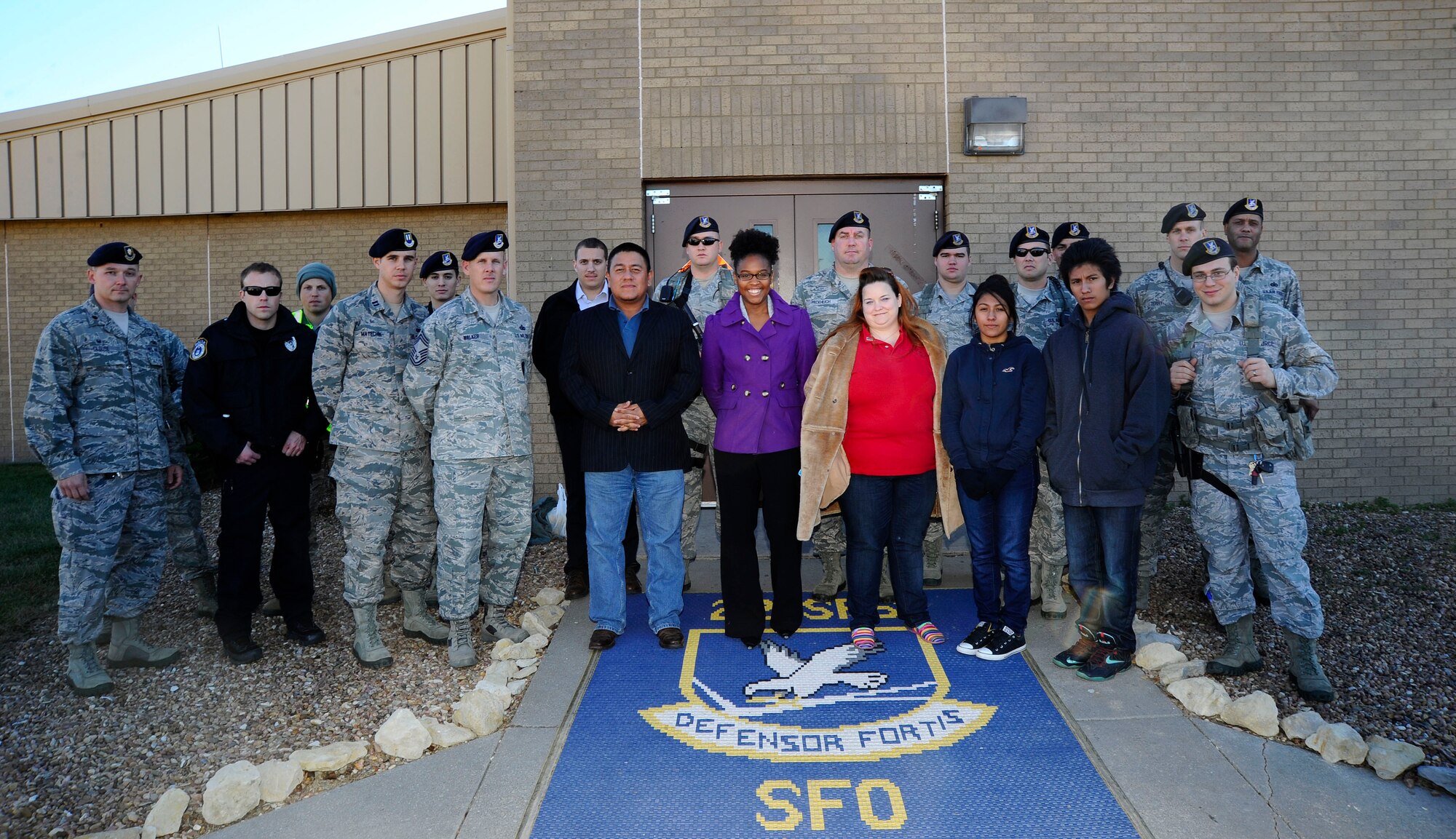 22nd Security Forces Squadron Defenders pose with members of the Kansas DUI Impact Center, Nov. 25, 2014, at McConnell Air Force Base, Kan. The two groups partnered up to raise awareness about the negative effects of drunk driving and the severe impact that it can have on people. (U.S. Air Force photo/Senior Airman Victor J. Caputo)