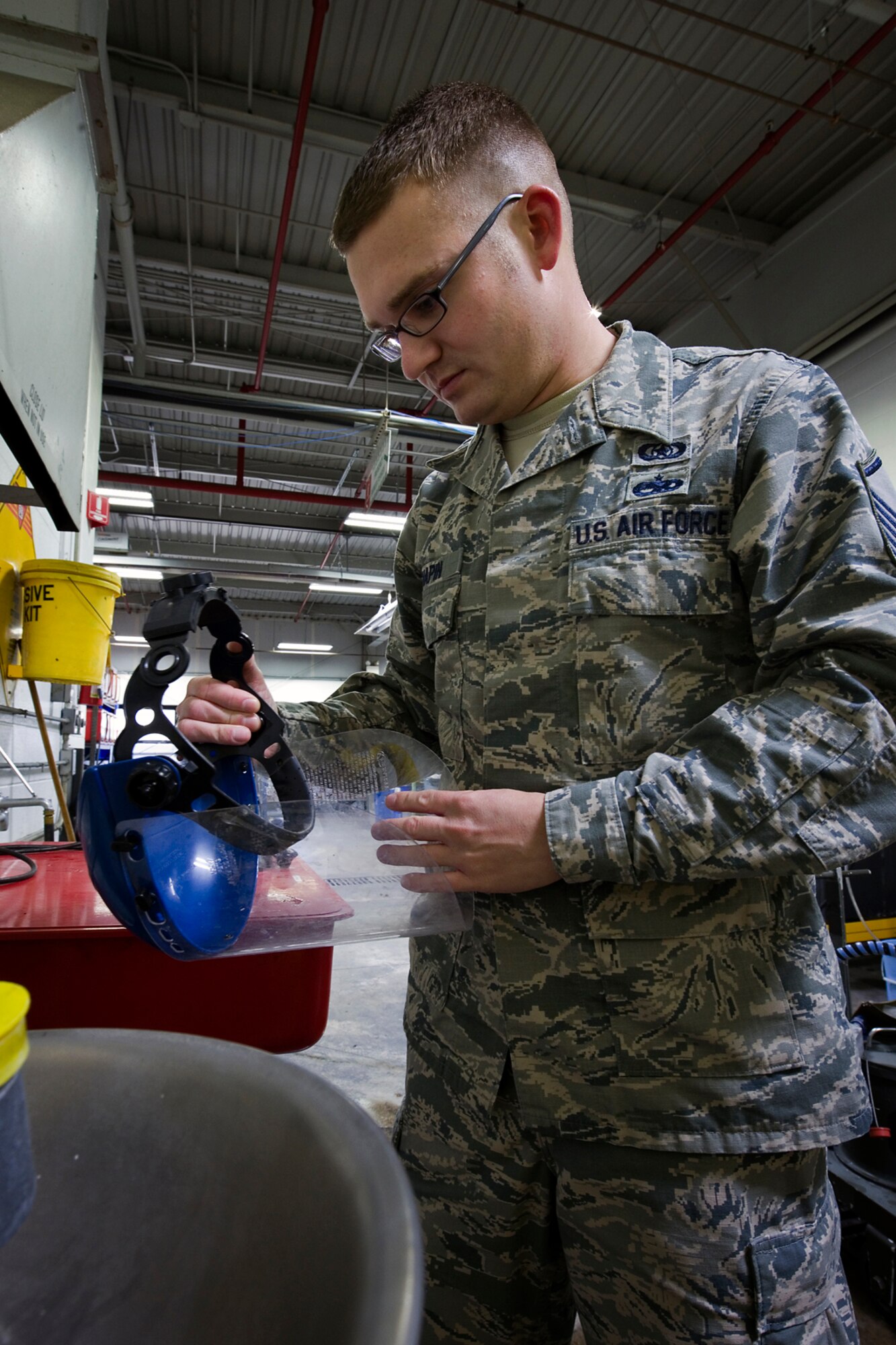 Master Sgt. Zachary Chapin, 434th Air Refueling Wing noncommissioned officer in charge of ground safety, checks the personal protective gear during a recent safety inspection at Grissom Air Reserve Base, Ind., Dec. 3, 2014. The safety office helps ensure Grissom's workforce gets the job done without getting hurt. (U.S. Air Force photo/Tech. Sgt. Douglas Hays) 
