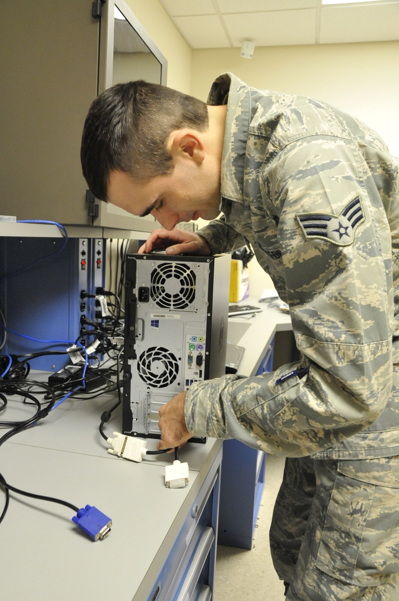 Senior Airman Chase Butters, a 403rd Communications Flight client system technician, readies a computer for the set-up in the computer lab of the 403rd CF here Nov. 1.  This set-up will include program installation, virus protection, domain connection and other set-ups required before it is used to replace an aging asset.  (U.S. Air Force photo/Master Sgt. Jessica L. Kendziorek)