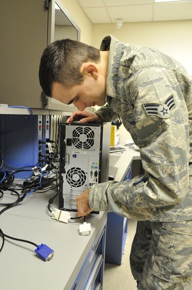 Senior Airman Chase Butters, a 403rd Communications Flight client system technician, readies a computer for the set-up in the computer lab of the 403rd CF here Nov. 1.  This set-up will include program installation, virus protection, domain connection and other set-ups required before it is used to replace an aging asset.  (U.S. Air Force photo/Master Sgt. Jessica L. Kendziorek)