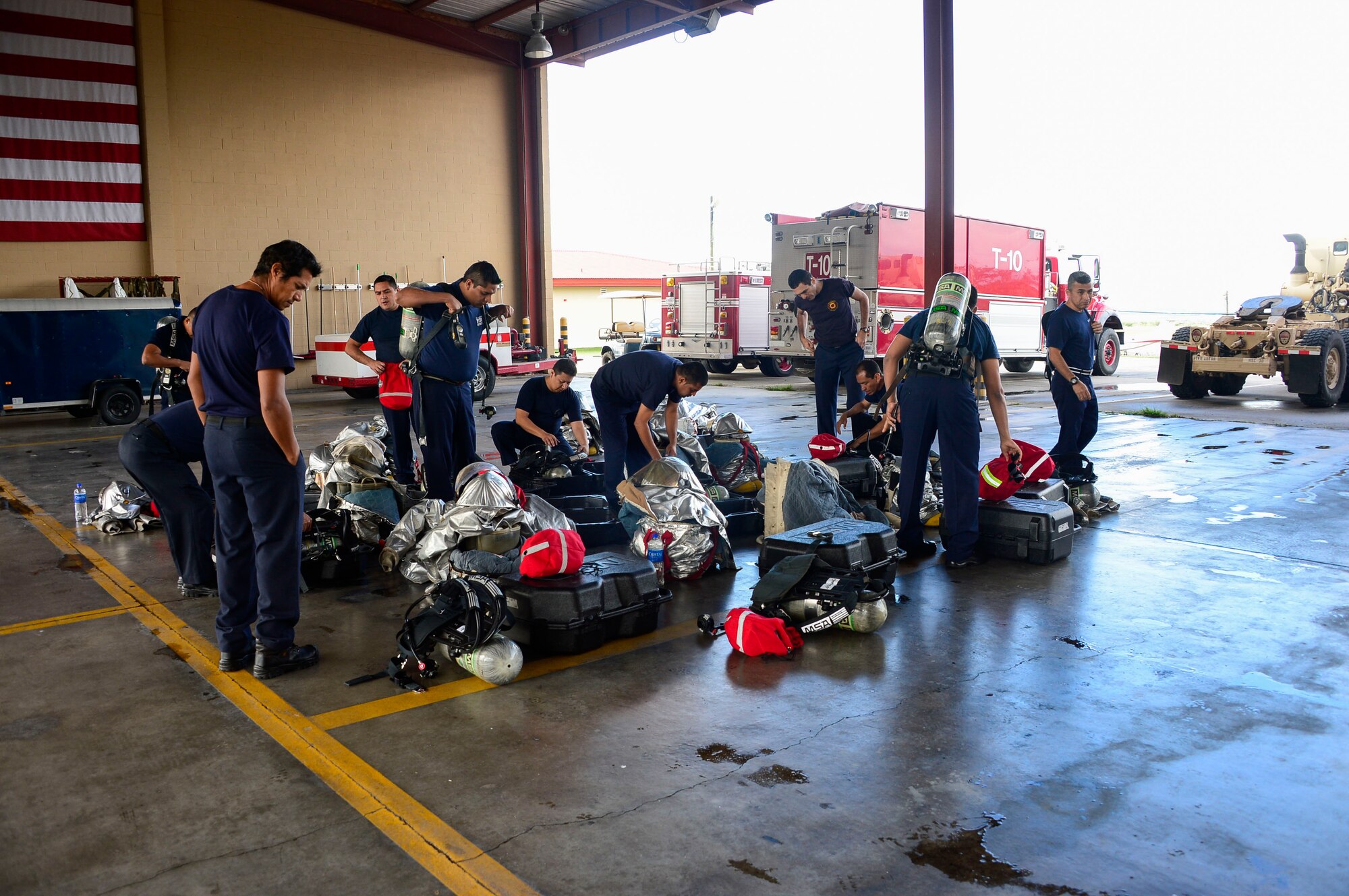 Firefighters from El Salvador check their personal protective equipment and self-contained breathing apparatus during an orientation given by the 612th Air Base Squadron firefighters  on Soto Cano Air Base, Honduras, Dec. 3, 2014.  The 612th ABS firefighters facilitated El Salvador’s Autonomous Executive Port Commission airport firefighter qualification by providing live-fires.  The Salvadoran airport firefighters have a requirement very similar to the United States standards that requires members of their airport fire departments to be qualified annually on their ability to control a live-fire.   (U.S. Air Force photo/Tech. Sgt. Heather Redman)