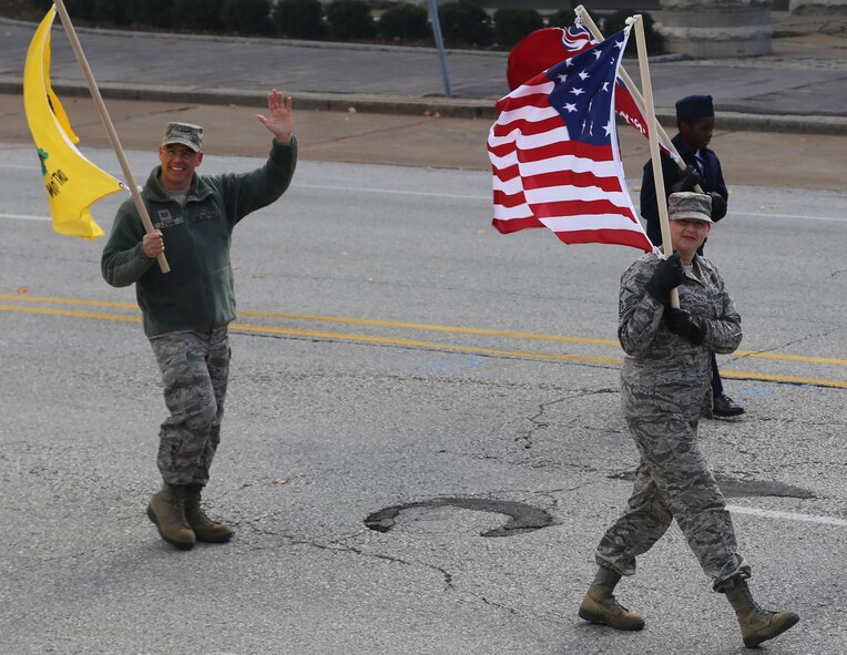 Patriotism was on display as the 932nd Airlift Wing walked in the recent Veterans Day Parade in Saint Louis.  At left, Tech. Sgt. Christopher Parr, public affairs specialist, waves to the crowds as Master Sgt. Heather, 932nd Airlift Wing Equal Opportunity Office, enjoys the time with her unit interacting with veterans and the public.  (U.S. Air Force photo/Maj. Stan Paregien)