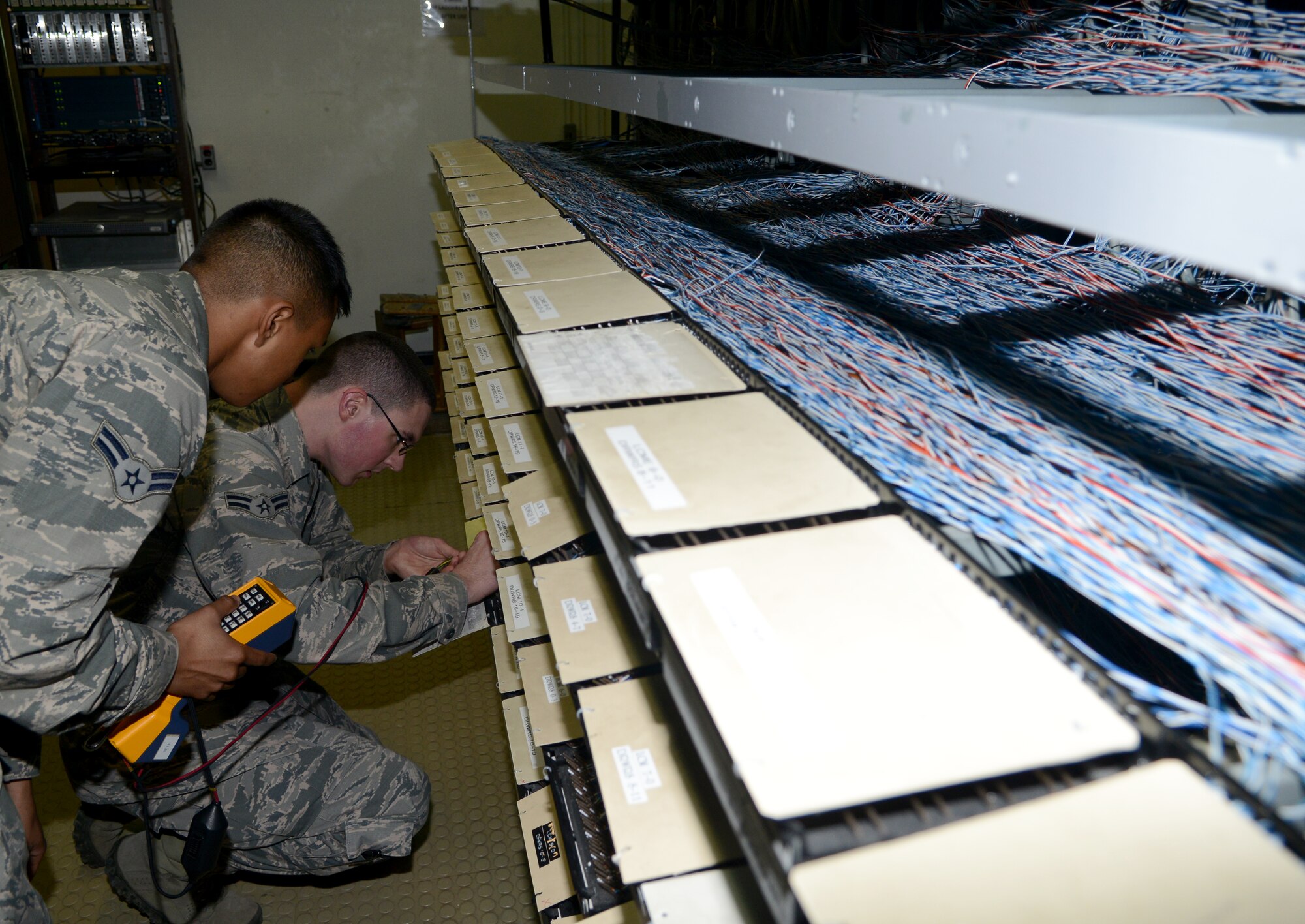 Members of the 39th Communications Squadron Cyber Transport Section, trouble shoot a telephone connection issue Dec. 3, 2014, at Incirlik Air Base, Turkey. The 39th CS has many sections that helped their squadron win the Air Force Chief of Safety Cyber Safety Award and is now competing at the Air Force level. (U.S. Air Force photo by Staff Sgt. Caleb Pierce/Released)