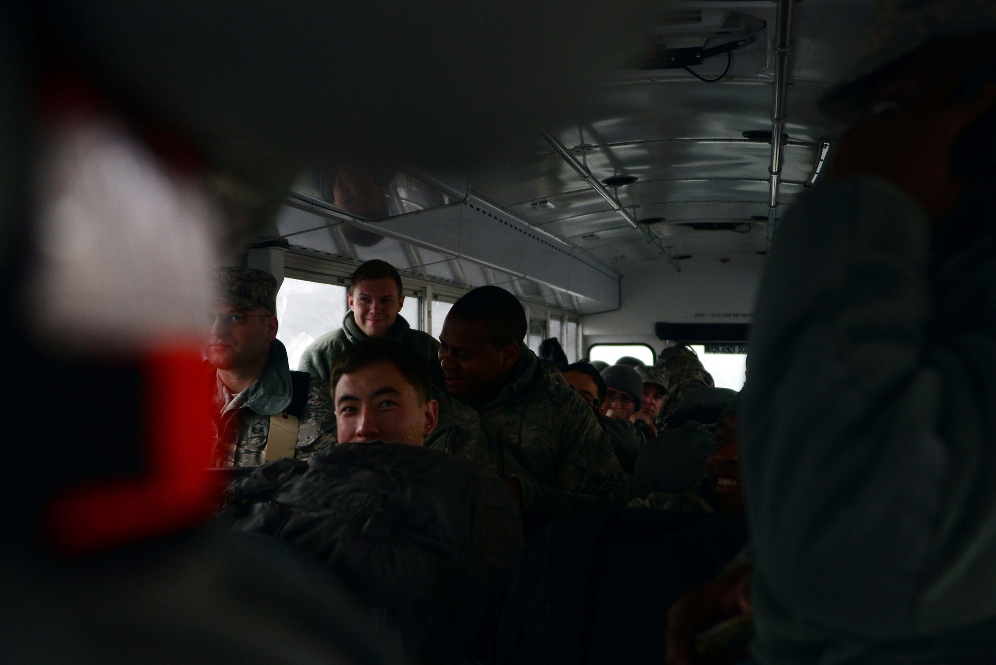 Airmen from the 35th Fighter Wing wait on a bus Dec. 4, 2014, before being processed through a Personnel Deployment Function line at Misawa Air Base, Japan. The process was part of Beverly Sunrise 15-1, an exercise across the Pacific theater that tested the readiness of Airmen to prepare and deploy at a moment’s notice. (U.S. Air Force photo by Staff Sgt. Derek VanHorn/Released)