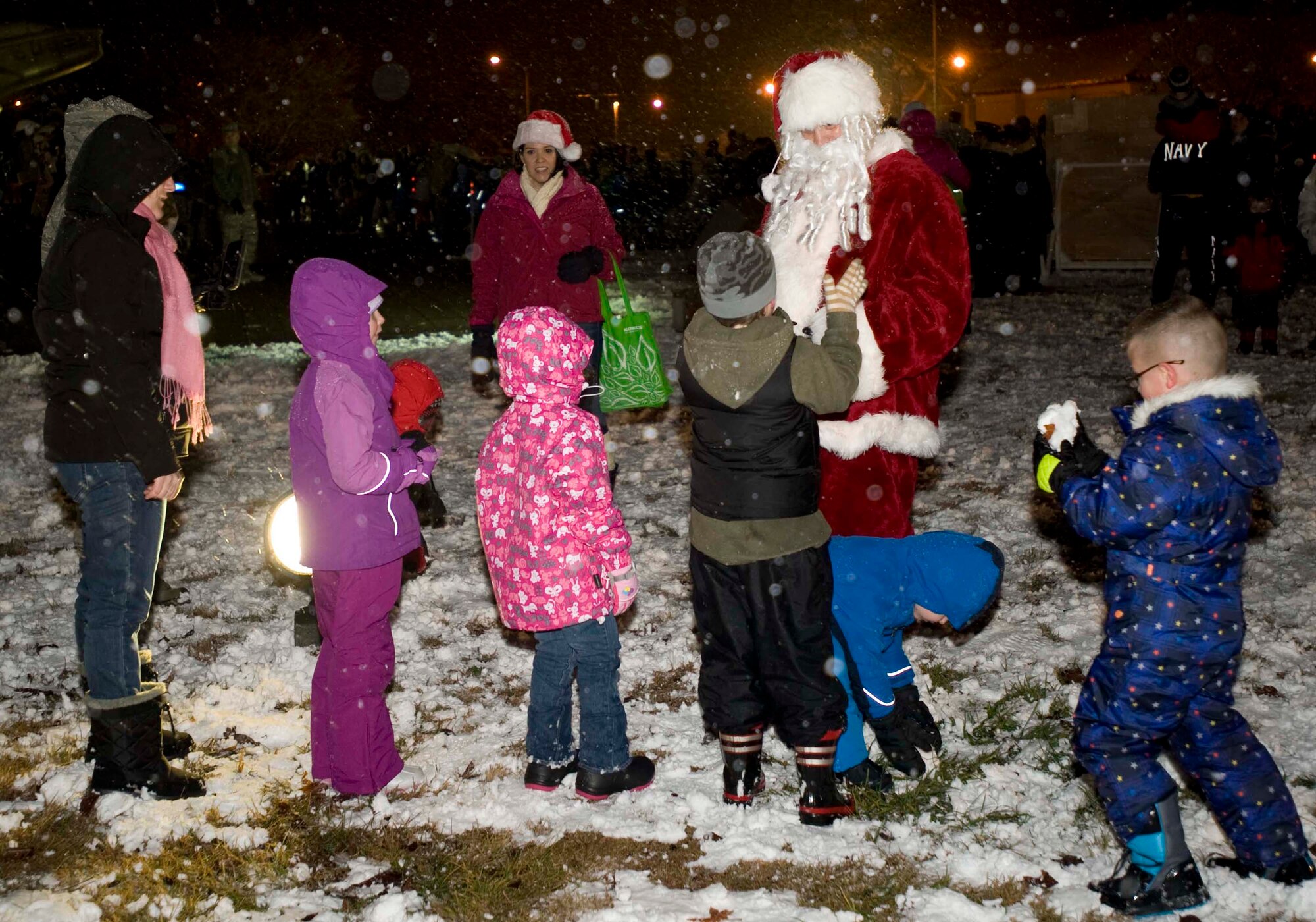 Misawa Air Base children speak with Santa Claus before the annual Tree Lighting Ceremony, at Misawa Air Base, Japan, Dec. 2, 2014. More than 175 attendees enjoyed hot chocolate while they watched a holiday music performance by American and Japanese children. (U.S. Air Force photo/Staff Sgt. Tong Duong/ Released) 