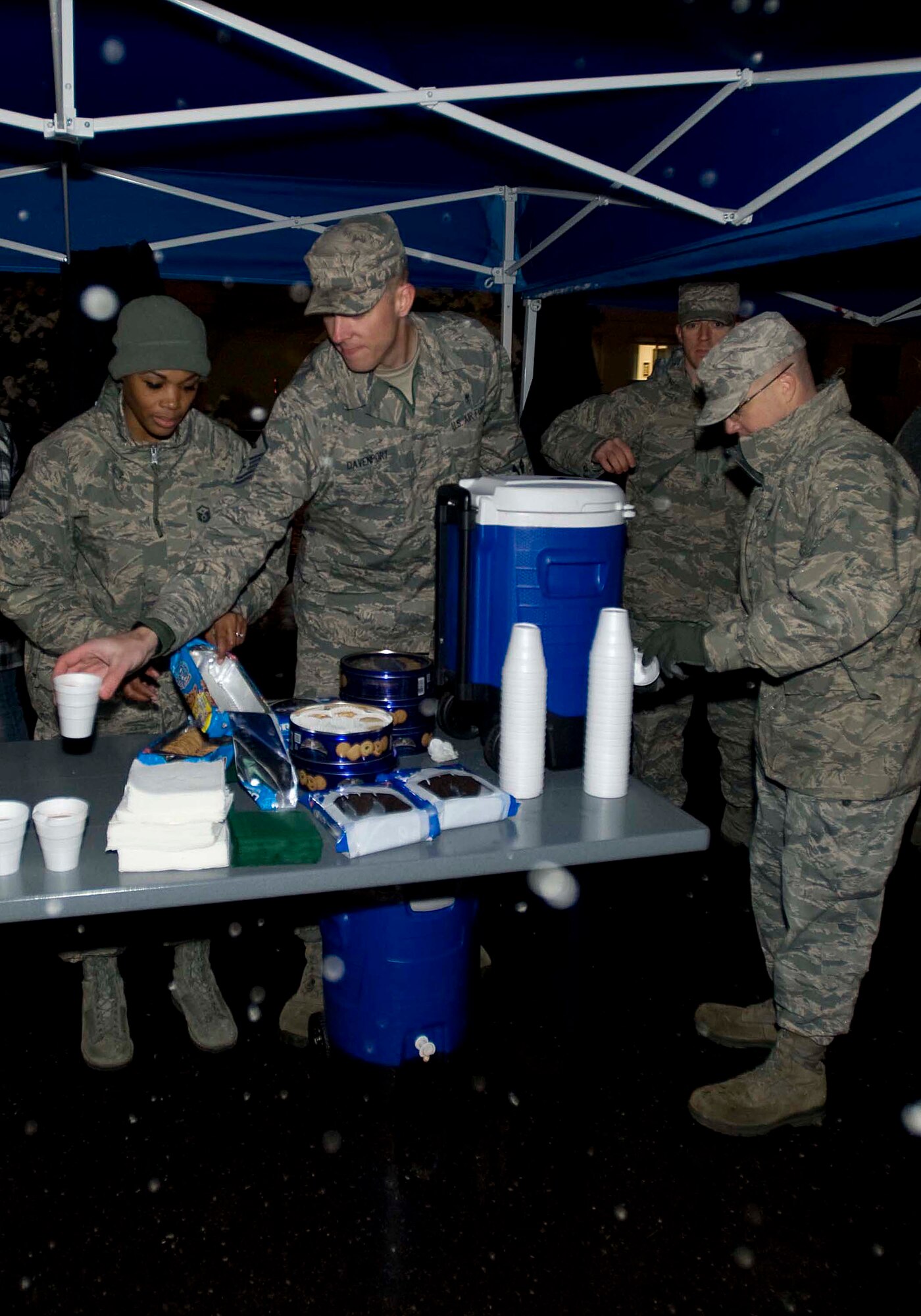 Members of the First Sergeant’s Council prepare hot chocolate and cookies during the annual Tree Lighting Ceremony at Misawa Air Base, Japan, Dec. 2, 2014. Hot beverages were a welcomed delight as attendees enjoyed holiday songs performed by American and Japanese children at Risner Circle during the first snow fall of the year. (U.S. Air Force photo/Staff Sgt. Tong Duong/ Released)