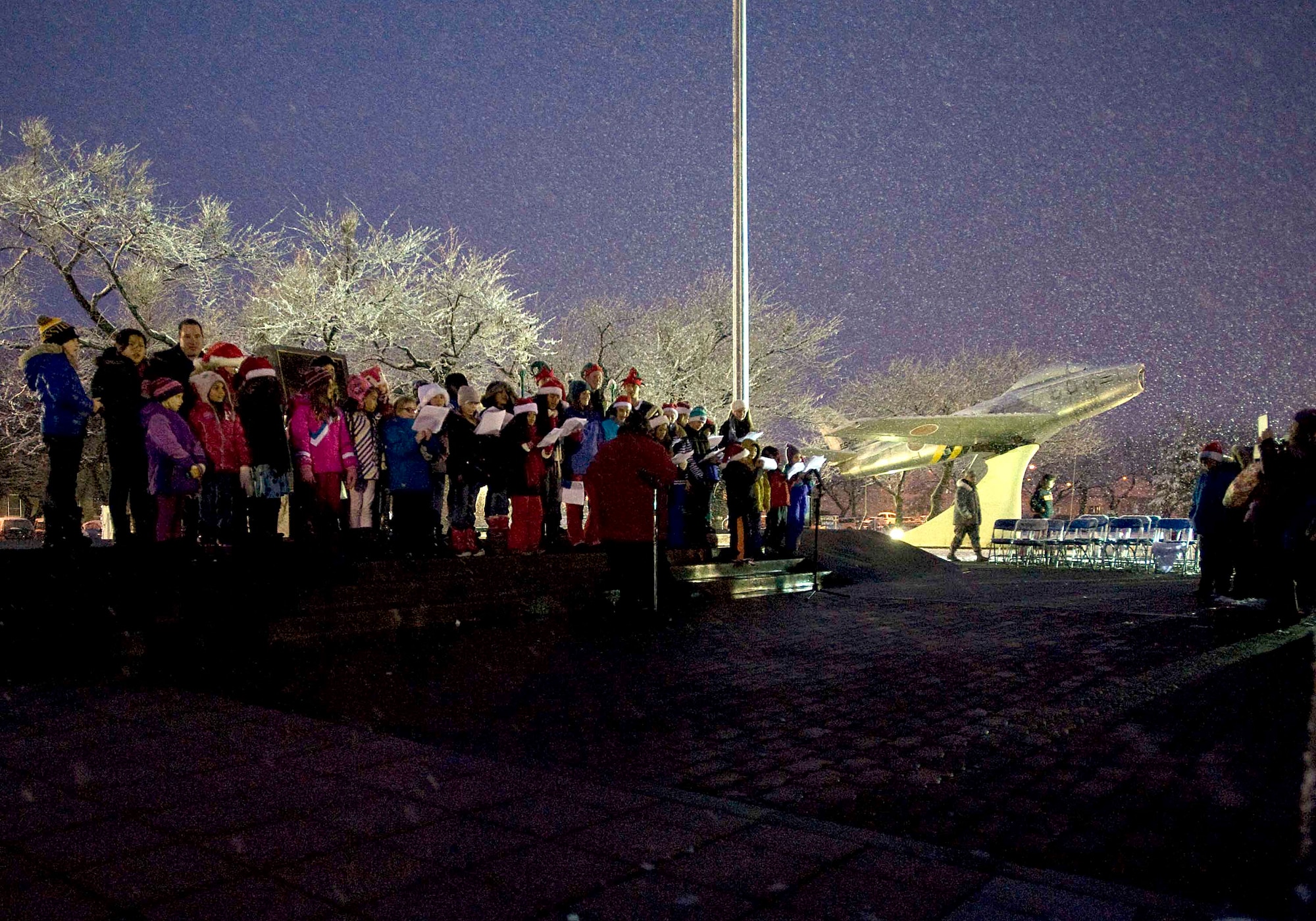 American and Japanese children sing holiday songs during the annual Tree Lighting Ceremony at Misawa Air Base, Dec. 2, 2014. Families enjoyed live entertainment, squadron holiday card contest and lighting of the tree, which first started on Dec. 4, 1980. (U.S. Air Force photo/Staff Sgt. Tong Duong/ Released)