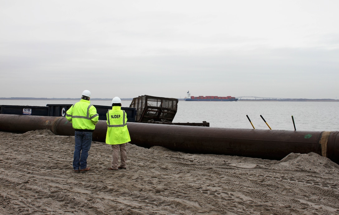 Bill Dixon (right), Manager of the NJDEP Bureau of Coastal Engineer discusses beachfill operations with NJDEP Chief of Staff Magdalena Padilla at Oakwood Beach, N.J. in December of 2014. USACE and NJDEP have partnered to construct projects along the New Jersey shore designed to reduce damages from future storm events. 