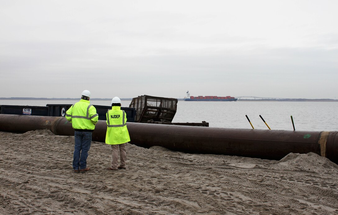 Bill Dixon (right), Manager of the NJDEP Bureau of Coastal Engineer discusses beachfill operations with NJDEP Chief of Staff Magdalena Padilla at Oakwood Beach, N.J. in December of 2014. USACE and NJDEP have partnered to construct projects along the New Jersey shore designed to reduce damages from future storm events. 