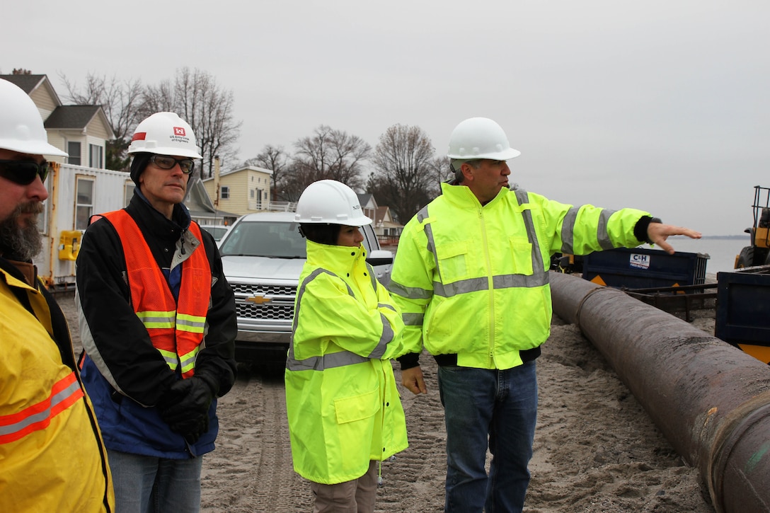 Bill Dixon (right), Manager of the NJDEP Bureau of Coastal Engineer discusses beachfill operations with NJDEP Chief of Staff Magdalena Padilla, and USACE Project Manager Dwight Pakan  at Oakwood Beach, N.J. in December of 2014. USACE and NJDEP have partnered to construct projects along the New Jersey shore designed to reduce damages from future storm events