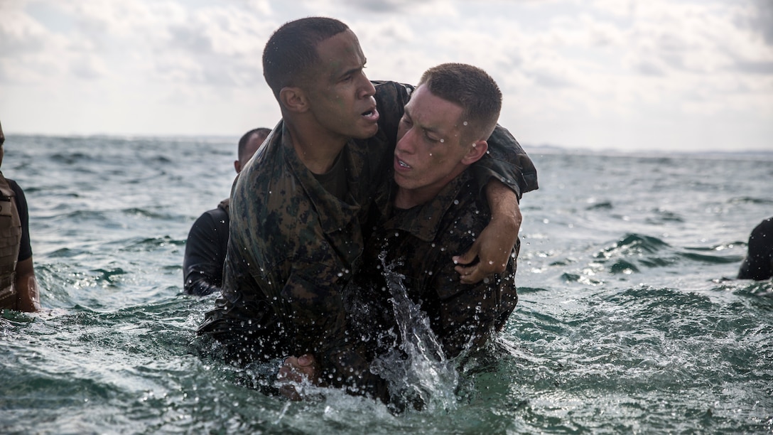 Sgt. Tirso O. Sotoortiz, left, and Cpl. Casey C. Kiser preform shallow water grappling techniques Nov. 21 at Kin Blue, Okinawa, during the culminating event for Marine Corps Martial Arts Instructor course class 1-15. The culminating event pushed the Marines and sailor to their limits mentally and physically while challenging them with MCMAP fundamentals. Marines and sailor in the course trained for three weeks in order to earn their instructor tab. After earning their tab, they now have the ability to practice and teach the disciplines and lessons they learned from the course. The course was run by Headquarters and Support Battalion, Marine Corps Installation Pacific-Marine Corps Base Camp Butler, Japan. Sotoortiz is an engineer equipment mechanic assigned to 3rd Maintenance Battalion, Combat Logistics Regiment 35, 3rd Marine Logistics Group. Kiser is a motor vehicle operator assigned to Combat Logistics Battalion 4, Combat logistics Regiment 3, 3rd Marine Logistic Group. (Marine Corps Photo by Cpl. Joey S. Holeman, Jr./ Released)