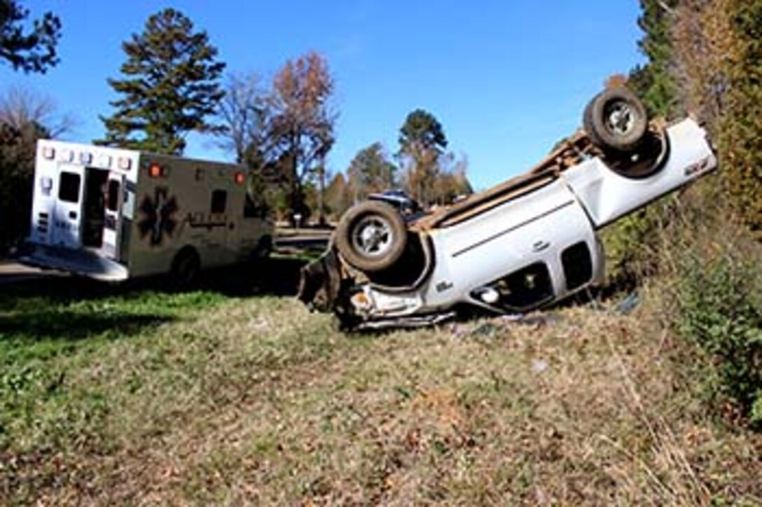 Marines with Bravo Company, 1st Battalion, 23rd Marine Regiment, 4th Marine Division, were the first on the scene of this overturned truck Nov. 26, 2014, after conducting a funeral detail. The woman inside, Patti Cranford, of Garrison, Texas, was on her way to the funeral when she lost control of her vehicle a mile away from the cemetery. (Photo by Scott Flowers) 