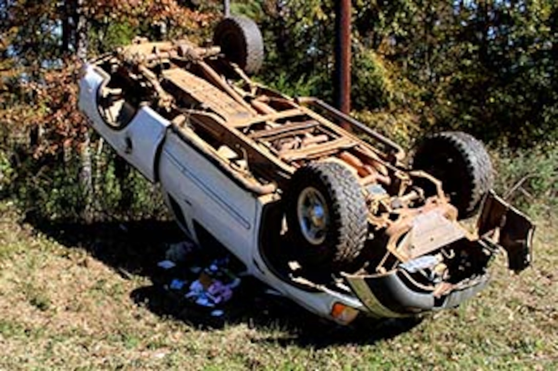 Marines with Bravo Company, 1st Battalion, 23rd Marine Regiment, 4th Marine Division, were the first on the scene of this overturned truck Nov. 26, 2014, after conducting a funeral detail. The woman inside, Patti Cranford, of Garrison, Texas, was on her way to the funeral when she lost control of her vehicle a mile away from the cemetery. (Photo by Scott Flowers) 