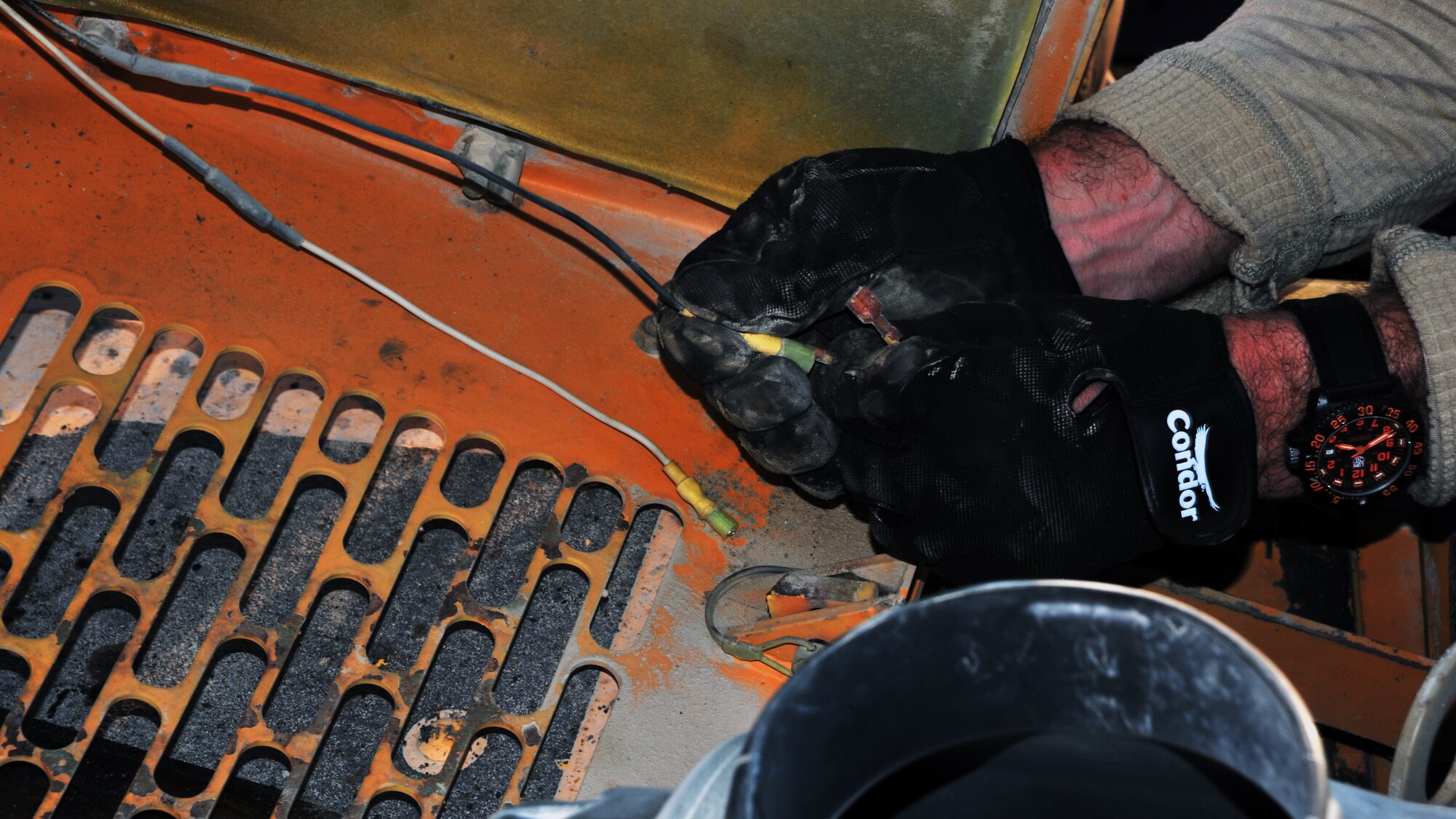 U.S. Air Force Senior Master Sgt. Adam Brothers, 557th Expeditionary Rapid Engineer Deployable Heavy Operational Repair Squadron Engineers (RED HORSE) Squadron pavement and construction, connects wire in order to provide functioning paver lights Dec. 2, 2014 at Bagram Airfield, Afghanistan. The primary mission of RED HORSE units is to assess, plan and establish contingency facilities/infrastructure to support contingency operations and combat missions. (U.S. Air Force photo by Staff Sgt. Whitney Amstutz/released)