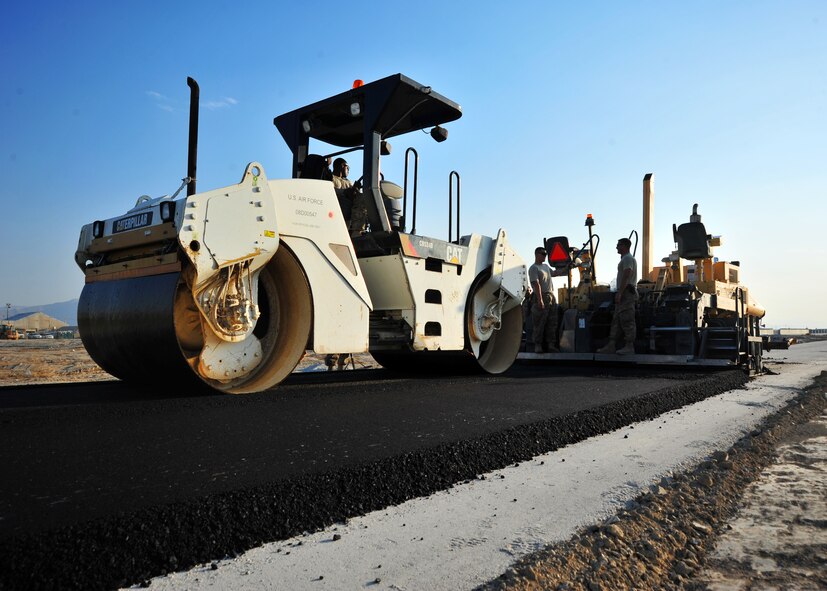 U.S. Air Force Airmen assigned to the 557th Expeditionary Rapid Engineer Deployable Heavy Operational Repair Squadron Engineers (RED HORSE) Squadron man their machinery during a construction project Dec. 2, 2014 at Bagram Airfield, Afghanistan. The Airmen, who spent approximately one month at Bagram, completed a high-value project to expedite the 455th Air Expeditionary Wing mission. (U.S. Air Force photo by Staff Sgt. Whitney Amstutz/released)