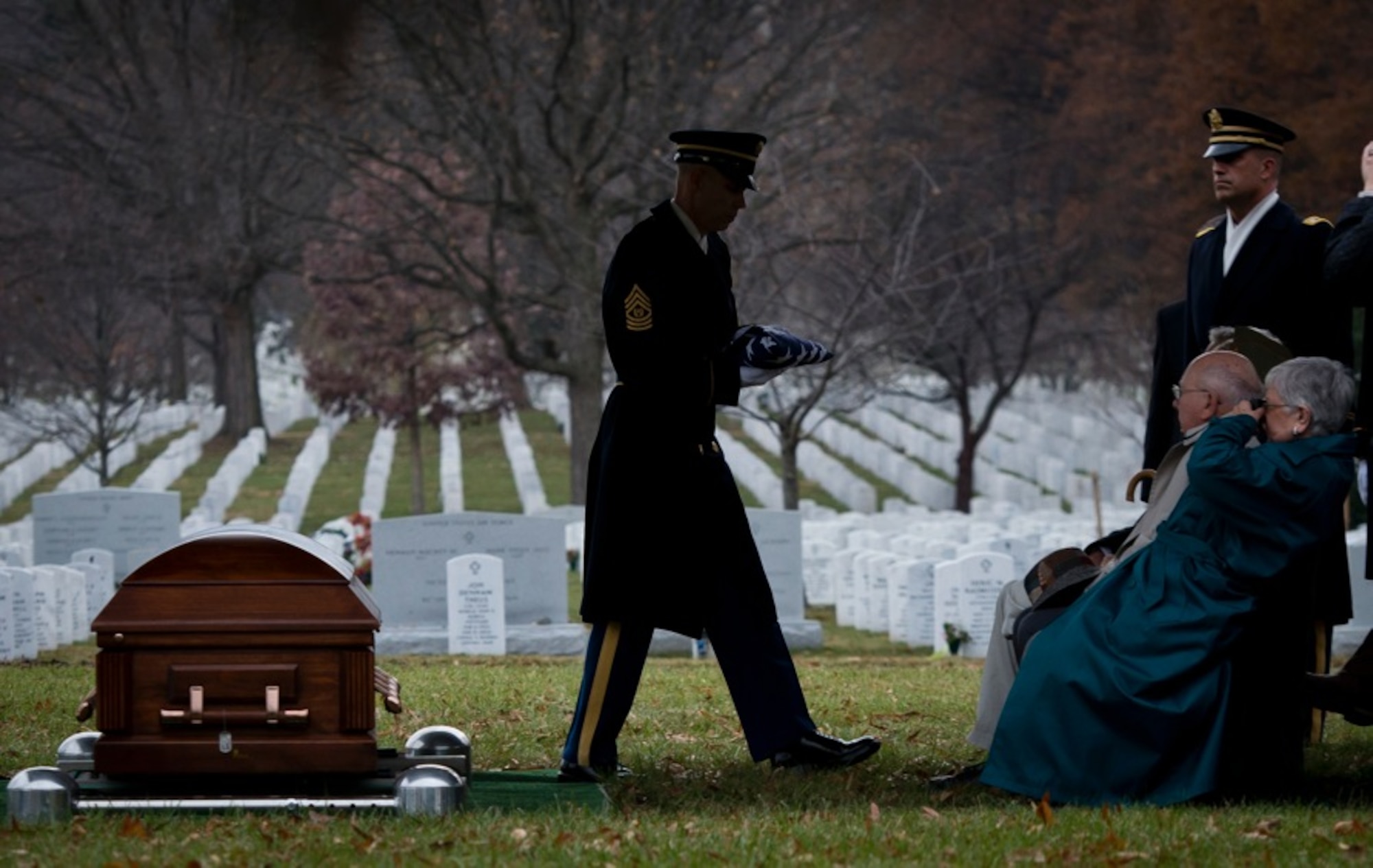 Command Sgt. Maj. Michael Callaghan-McCann prepares to present the flag to a family member of Army Air Forces Sgt. Charles A. Gardner Dec. 4, 2014, in Arlington National Cemetery. Gardner, along with 11 of his fellow crew members, went missing on April 10, 1944, after his B-24D Liberator aircraft was shot down over New Guinea. Callaghan-McCann is with the 1st Battalion, 3rd Infantry. (U.S. Air Force photo/Staff Sgt. Andrew Lee)