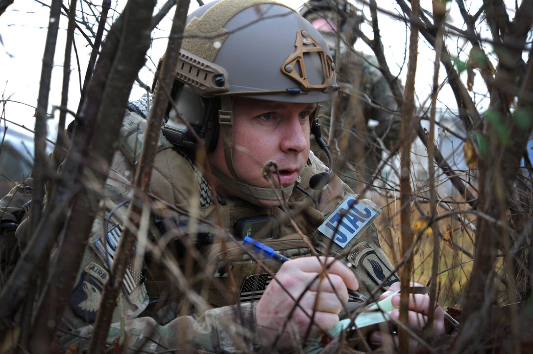 Tech. Sgt. Andrew Carpenter writes down coordinates of a simulated target, Dec. 2, 2014, in Barcis, Italy. During a week-long exercise near Aviano Air Base, Italy, U.S. military and the Dutch army train with 555th Fighter Squadron pilots to stay current in their proficiencies. The training allows joint tactical air controllers to coordinate with F-16 Fighting Falcons and practice calling in airstrikes on simulated targets in the mountains. Carpenter is a 2nd Air Support Operations Squadron JTAC. (U.S. Air Force photo/Senior Airman Matthew Lotz)