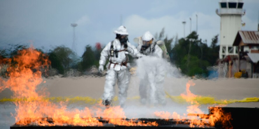 Firefighters from El Salvador start to extinguish a simulated petroleum, oil, and lubricants running pool fire during the El Salvador’s Autonomous Executive Port Commission airport firefighter live fires Dec. 3, 2014, on Soto Cano Air Base, Honduras. The 612th Air Base Squadron firefighters facilitated El Salvador’s Autonomous Executive Port Commission airport firefighter qualification by providing live fires. The Salvadoran airport firefighters have a requirement very similar to the United States standards that requires members of their airport fire departments to be qualified annually on their ability to control a live fire. (U.S. Air Force photo/Tech. Sgt. Heather Redman)