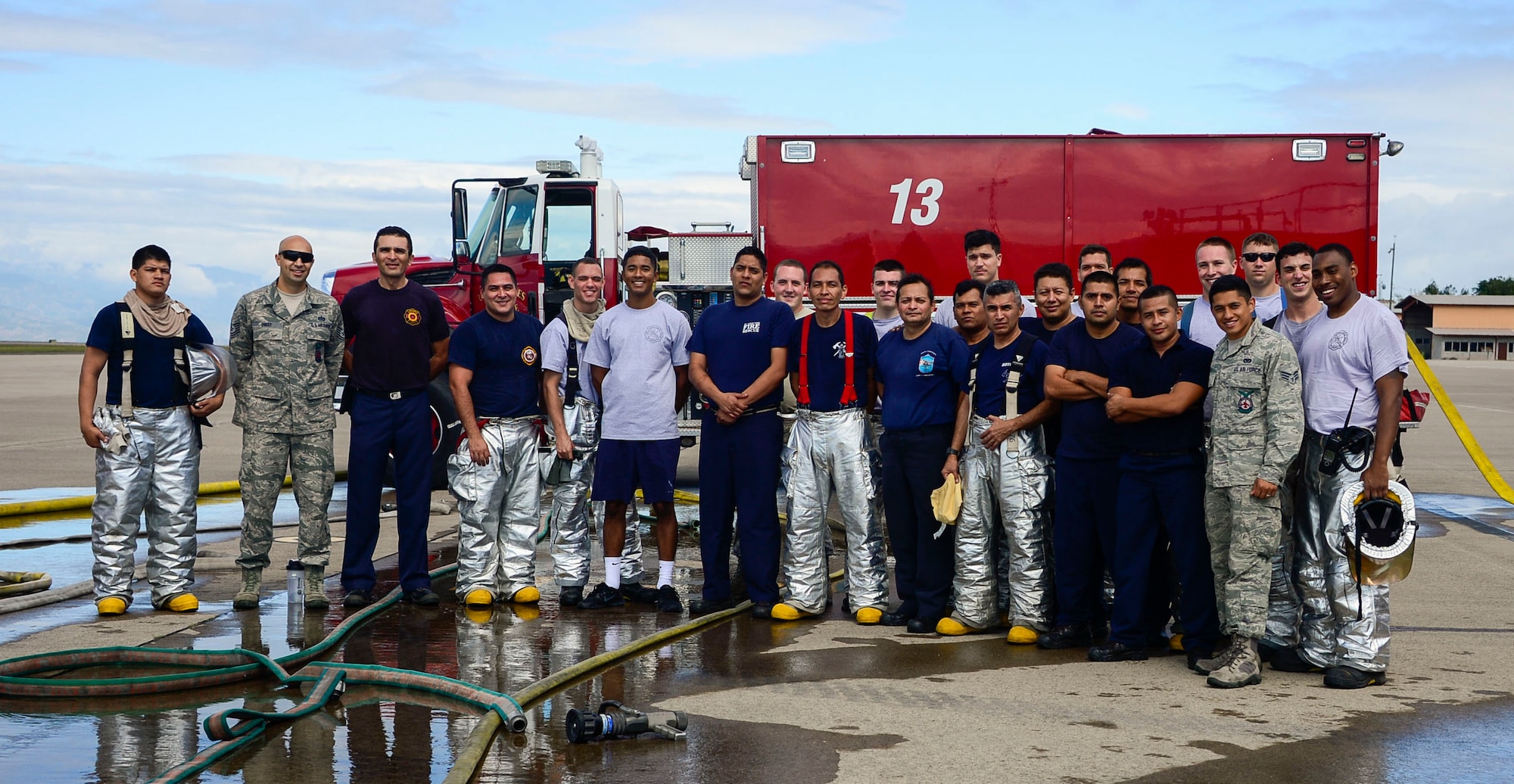Firefighters from the 612th Air Base Squadron and El Salvador gather together after El Salvador’s Autonomous Executive Port Commission airport firefighter live fires Dec. 3, 2014, on Soto Cano Air Base, Honduras. The 612th ABS firefighters facilitated El Salvador’s Autonomous Executive Port Commission airport firefighter qualification by providing live fires. The Salvadoran airport firefighters have a requirement very similar to the United States standards that requires members of their airport fire departments to be qualified annually on their ability to control a live fire. (U.S. Air Force photo/Tech. Sgt. Heather Redman) 