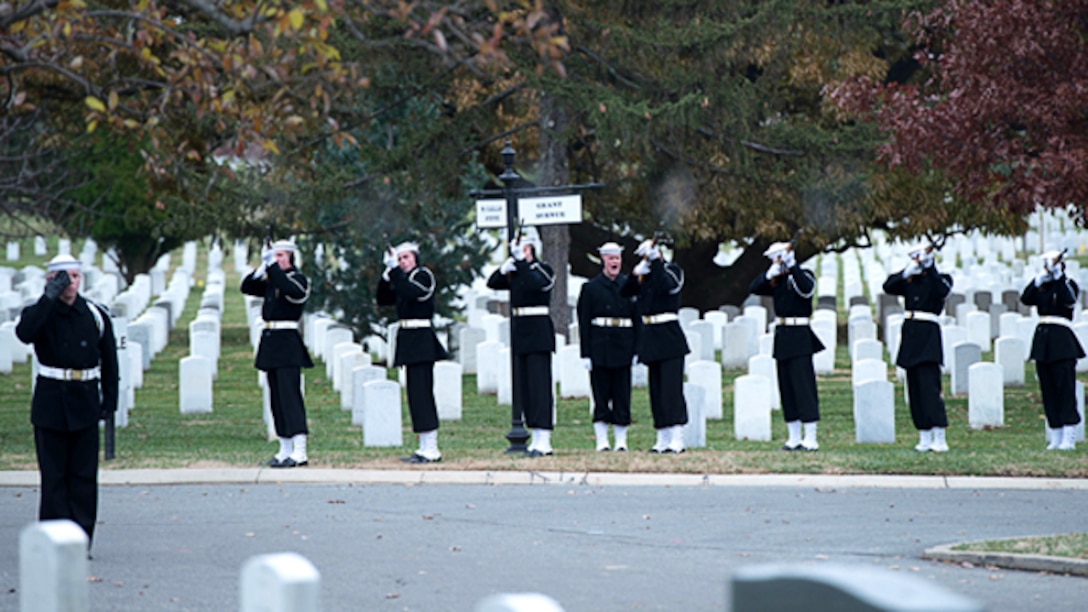 The Navy Honor Guard fires a volley as part of the 21-gun salute in honor of Capt. Eli Takesian, the eighth Chaplain of the Marine Corps, at the Arlington National Cemetery, Arlington, Va. on Dec. 4, 2014. Takesian died May 20, 2014 at the Walter Reed National Military Medical Center in Bethesda, Md. Takesian is most renowned for the care and aid he provided to the Marines of 1st Battalion, 5th Marine Regiment at the bloody battle of Hue City during the Vietnam War.