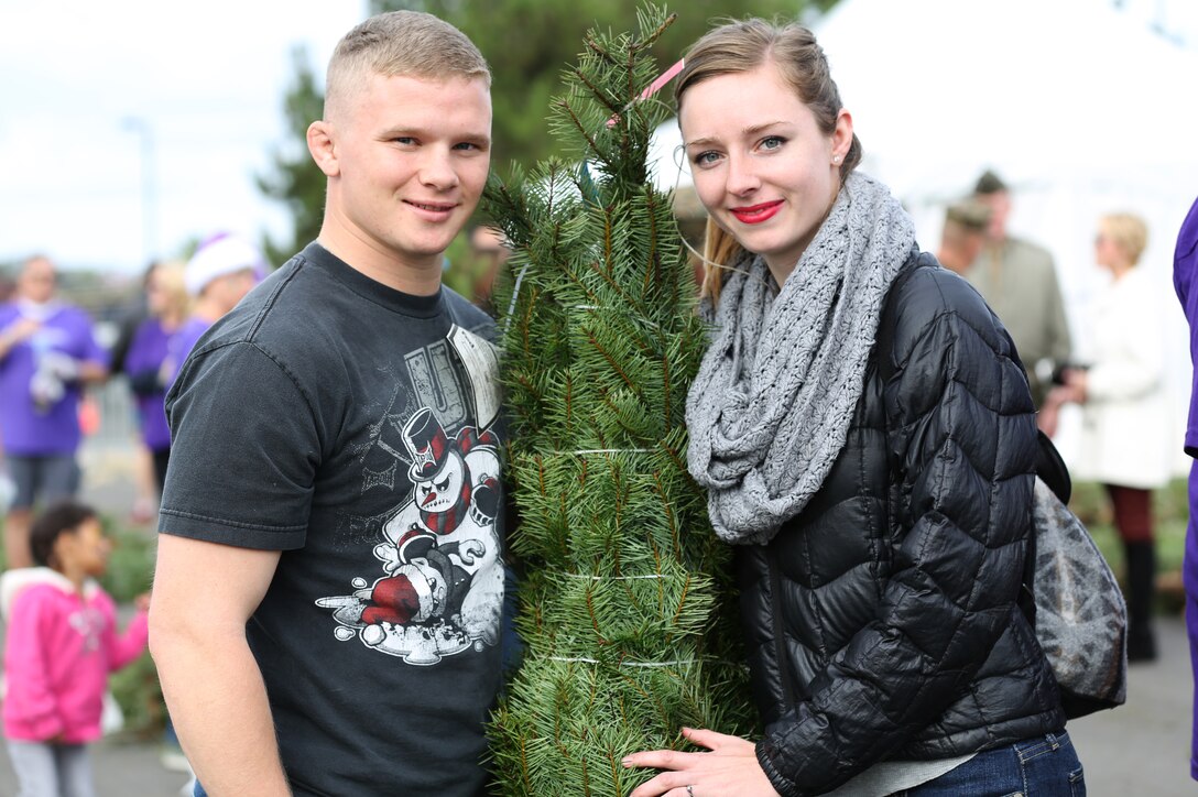 CAMP PENDLETON, Calif. -- A Christmas tree giveaway for service members was held at the Paige Fieldhouse parking lot here, Dec. 5. Approximately 1,000 Marines, Sailors and family members received Christmas trees and other giveaways through the Trees for Troops program.(Photos by Lance Cpl. Asia J. Sorenson) 