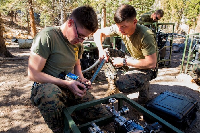 Water support technicians with Combat Logistics Battalion 6, 2nd Marine Logistics Group, set up a lightweight water purification system at a training area in the Marine Corps Mountain Warfare Training Center, Bridgeport, Calif., Oct. 20, 2014. CLB-6 teamed up with 2nd Battalion, 5th Marine Regiment, 1st Marine Division for the month-long Summer Mountain Warfare Exercise aboard MCMWTC, where they learned survival skills and tactics in the Sierra Nevada Mountains. The training package helps to ensure the readiness and relevance of 2nd MLG forces to be employed in support of combatant command requirements.