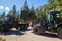 Private First Class Julieta Oranias, a heavy equipment operator with Combat Logistics 6, 2nd Marine Logistics Group, removes a container of supplies from the back of a trailer at a training area in the Marine Corps Mountain Warfare Training Center, Bridgeport, Calif., Oct. 20, 2014. CLB-6 teamed up with 2nd Battalion, 5th Marine Regiment, 1st Marine Division for the month-long Summer Mountain Warfare Exercise aboard MCMWTC, where they learned survival skills and tactics in the Sierra Nevada Mountains. The training package helps to ensure the readiness and relevance of 2nd MLG forces to be employed in support of combatant command requirements.
