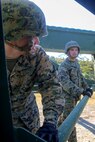 Cpl. Brandon Hunsinger, and Lance Cpl. Eddie Osteen, combat engineers with 8th Engineer Support Battalion, 2nd Marine Logistics Group, and natives of Philadelphia and Douglas, Ga. (respectively), secure a piece of a 12-bay, double-story, medium-girder bridge at Landing Zone Dove on Marine Corps Base Camp Lejeune, N.C., Nov. 19, 2014.  Marines with the unit constructed the bridge in less than six hours. Medium girder bridges are used to cross obstacles such as water and can support the weight of a tank.