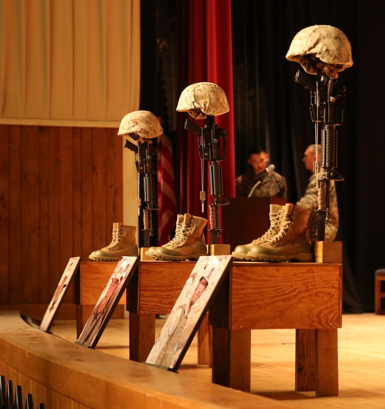 Battlefield crosses sit on stage for Staff Sgt. David Stewart, Cpl. Brandon Garabrant, and Cpl. Adam Wolff , during a memorial service held by 2nd Combat Engineer Battalion, 2nd Marine Division, aboard Camp Lejeune, N.C., Nov. 6, 2014. The practice of making battlefield crosses started during the American Civil War, and helped identify fallen service members on the field of battle. (U.S. Marine Corps photo by Lance Cpl. Justin T. Updegraff/Released)