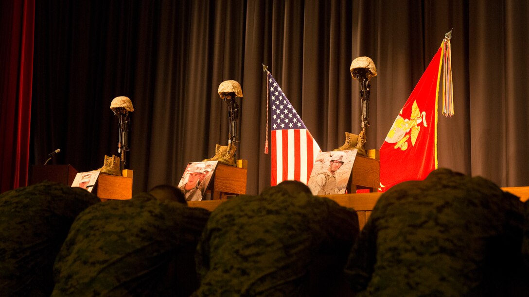 Marines with 2nd Combat Engineer Battalion, 2nd Marine Division, pay their respects to three fallen service members during a memorial service aboard Camp Lejeune, N.C., Nov. 6, 2014. The unit’s Marines approached the battlefield crosses in groups to pay their respect to Staff Sgt. David Stewart, Cpl. Brandon Garabrant, and Cpl. Adam F. Wolff, who were killed druing the battalion’s 2014 deployment to Afghanistan. (U.S. Marine Corps photo by Lance Cpl. Justin T. Updegraff/Released)