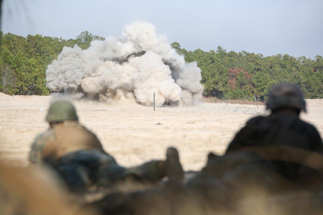 Position safety officers observe the detonation of an expedient line charge by Marines with Engineer Platoon, Headquarters and Service Company, Ground Combat Element Integrated Task Force, during an assault breaching exercise at Engineer Training Area 2 at Marine Corps Base Camp Lejeune, North Carolina, Dec. 3, 2014. (U.S. Marine Corps photo by Cpl. Paul S. Martinez/Released)