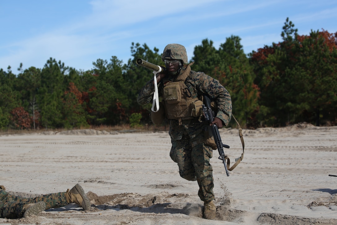 Lance Cpl. Amadu Kanu, combat engineer with Engineer Platoon, Headquarters and Service Company, Ground Combat Element Integrated Task Force, advances to an objective with an M1A2 Bangalore torpedo during an assault breaching exercise at Engineer Training Area 2 at Marine Corps Base Camp Lejeune, North Carolina,  Dec. 3, 2014. (U.S. Marine Corps photo by Cpl. Paul S. Martinez/Released)