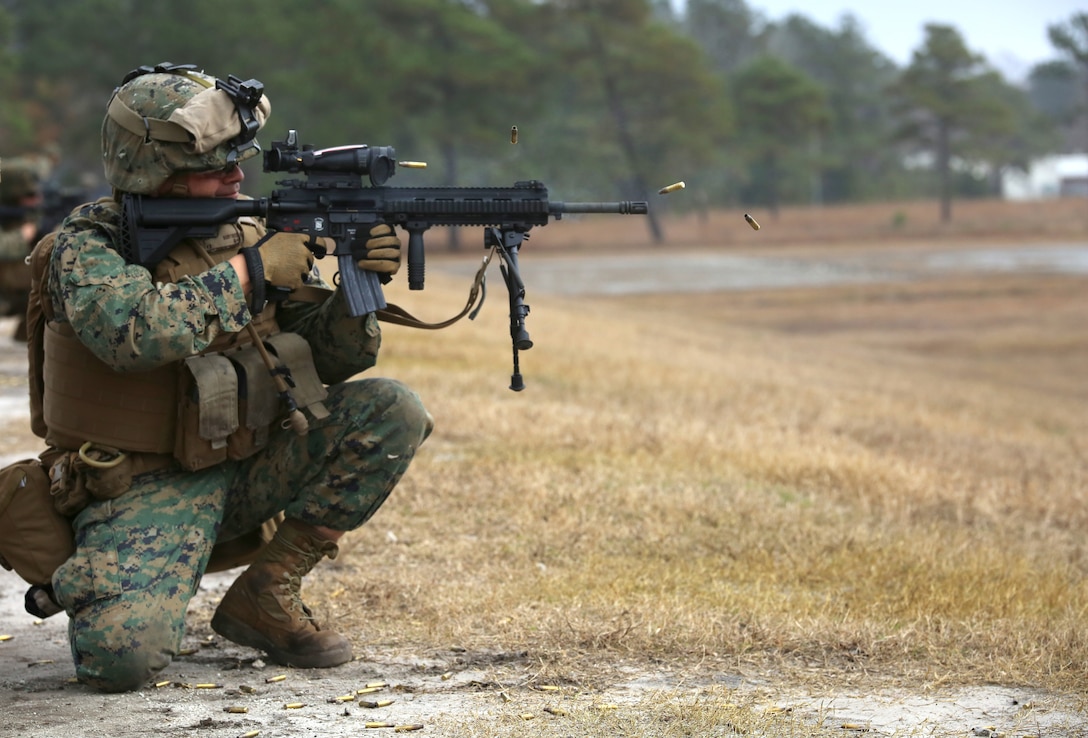 Sgt. Luis E. Martinez, rifleman with 1st Platoon, Company A, Ground Combat Element Integrated Task Force, engages known-distance targets with the M27 Infantry Automatic Rifle from the kneeling position during a three-day field exercise at the Verona Loop training area on Marine Corps Base Camp Lejeune, North Carolina, Dec. 3, 2014. (U.S. Marine Corps photo by Sgt. Alicia R. Leaders/Released)