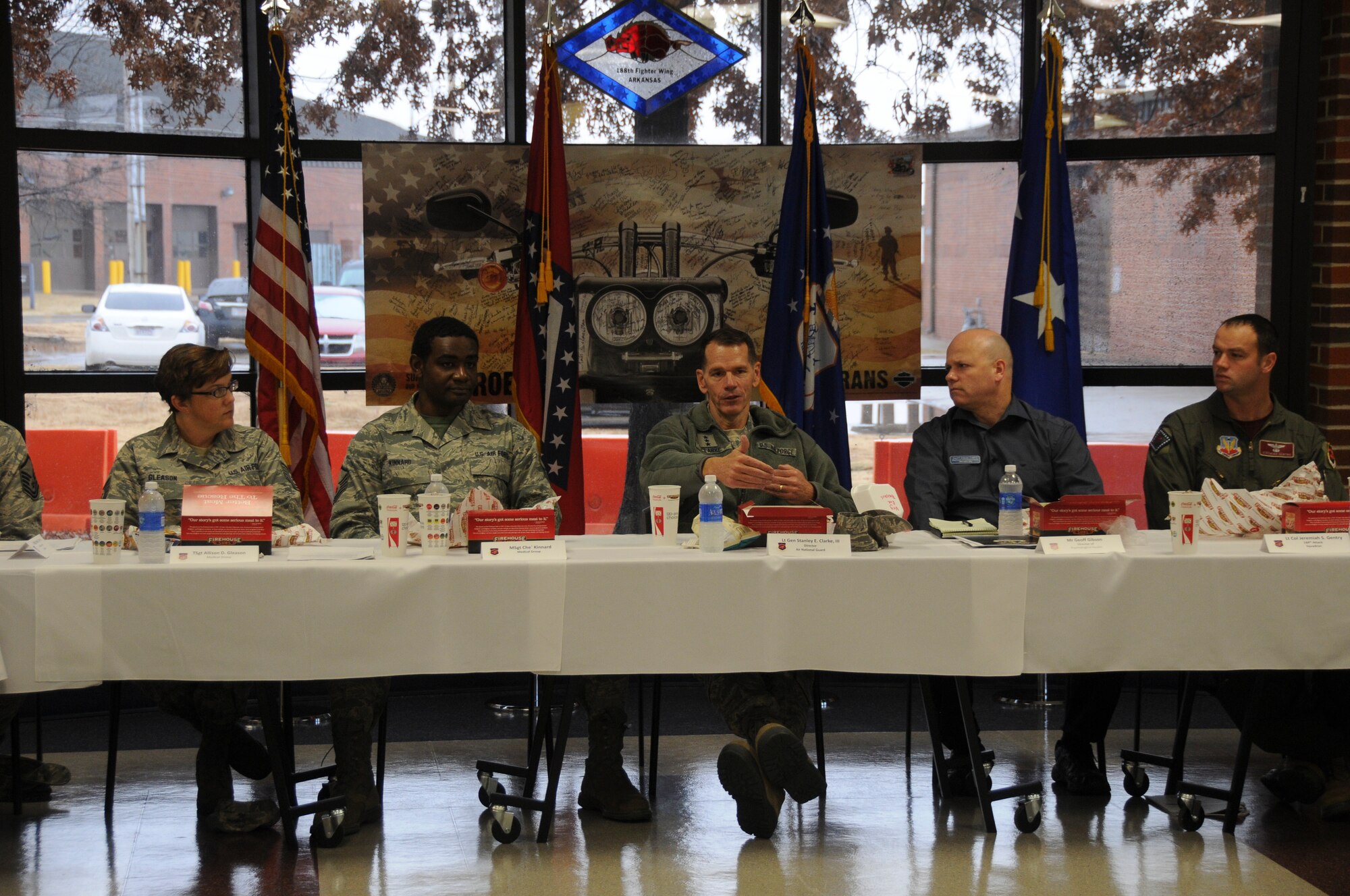 A group of Airmen from the 188th Wing join Lt. Gen. Stanley E. Clarke III, director of the Air National Guard, for lunch at Ebbing Air National Guard Base, Fort Smith, Ark. Dec. 5, 2014. Clarke engaged with Airmen of all levels and learned of their outstanding contributions to the mission at the 188th Wing. (U.S. Air National Guard photo by Airman 1st Class Cody Martin/released)