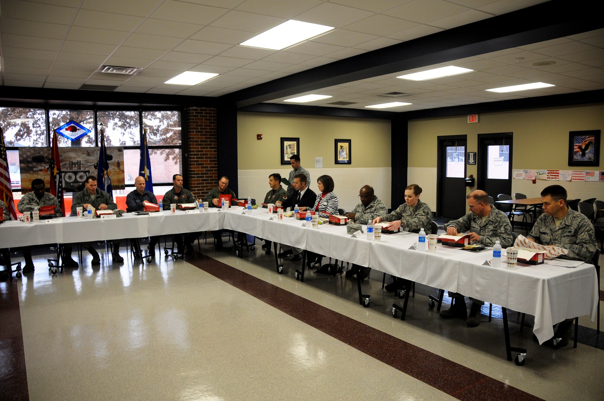 A group of Airmen from the 188th Wing join Lt. Gen. Stanley E. Clarke III, director of the Air National Guard, for lunch at Ebbing Air National Guard Base, Fort Smith, Ark. Dec. 5, 2014. Clarke engaged with Airmen of all levels and learned of their outstanding contributions to the mission at the 188th Wing. (U.S. Air National Guard photo by Airman 1st Class Cody Martin/released)