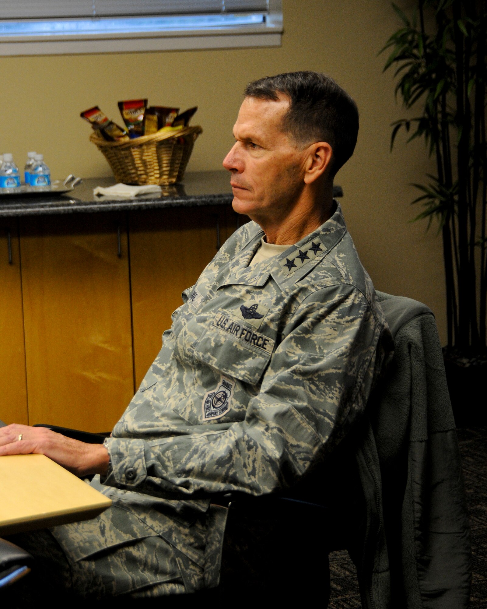 Lt. Gen. Stanley E. Clarke III, director of the Air National Guard, listens as Col. Mark Anderson, commander of the 188th Wing, presents the capabilities of the 188th WG during a briefing Dec. 5, 2014. Clarke toured the 188th Wing’s facilities, spoke with Airmen, and learned about the unit’s mission and contributions to the Air National Guard on his day-long visit. (U.S. Air National Guard photo by Airman 1st Class Cody Martin/released) 