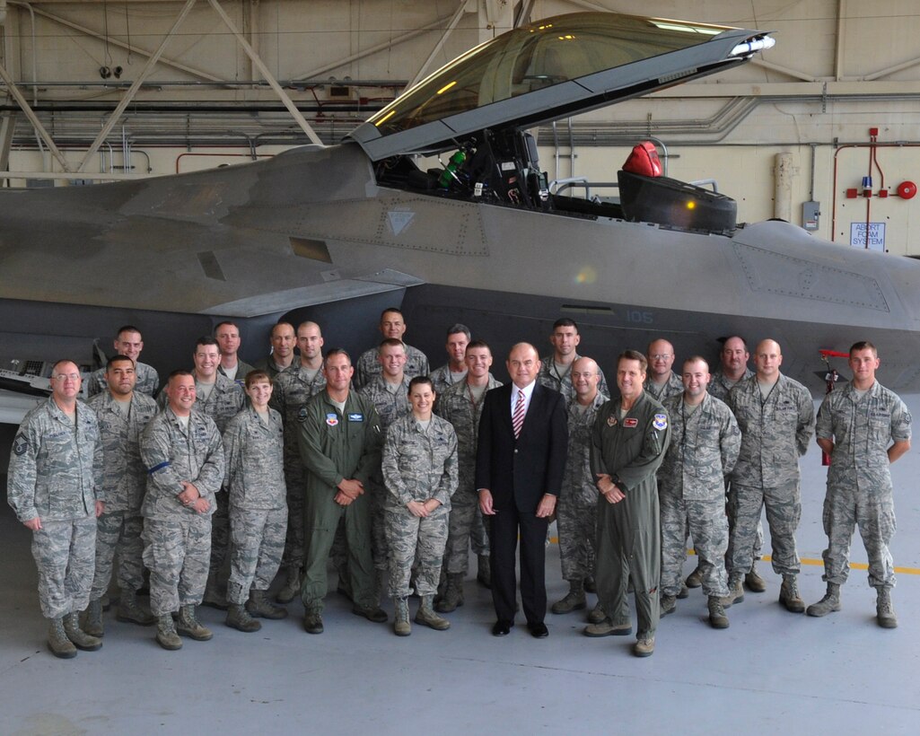 Air Force General Counsel Gordon Tanner takes a group photo in front of an F-22 Raptor with members of the 325th Fighter Wing on Tyndall Air Force Base Dec. 3. Tanner visited several organizations and their Airmen like the 44th Fighter Group and 1st Air Force. (U.S. Air Force photo by Airman 1st Class Ty-Rico Lea)