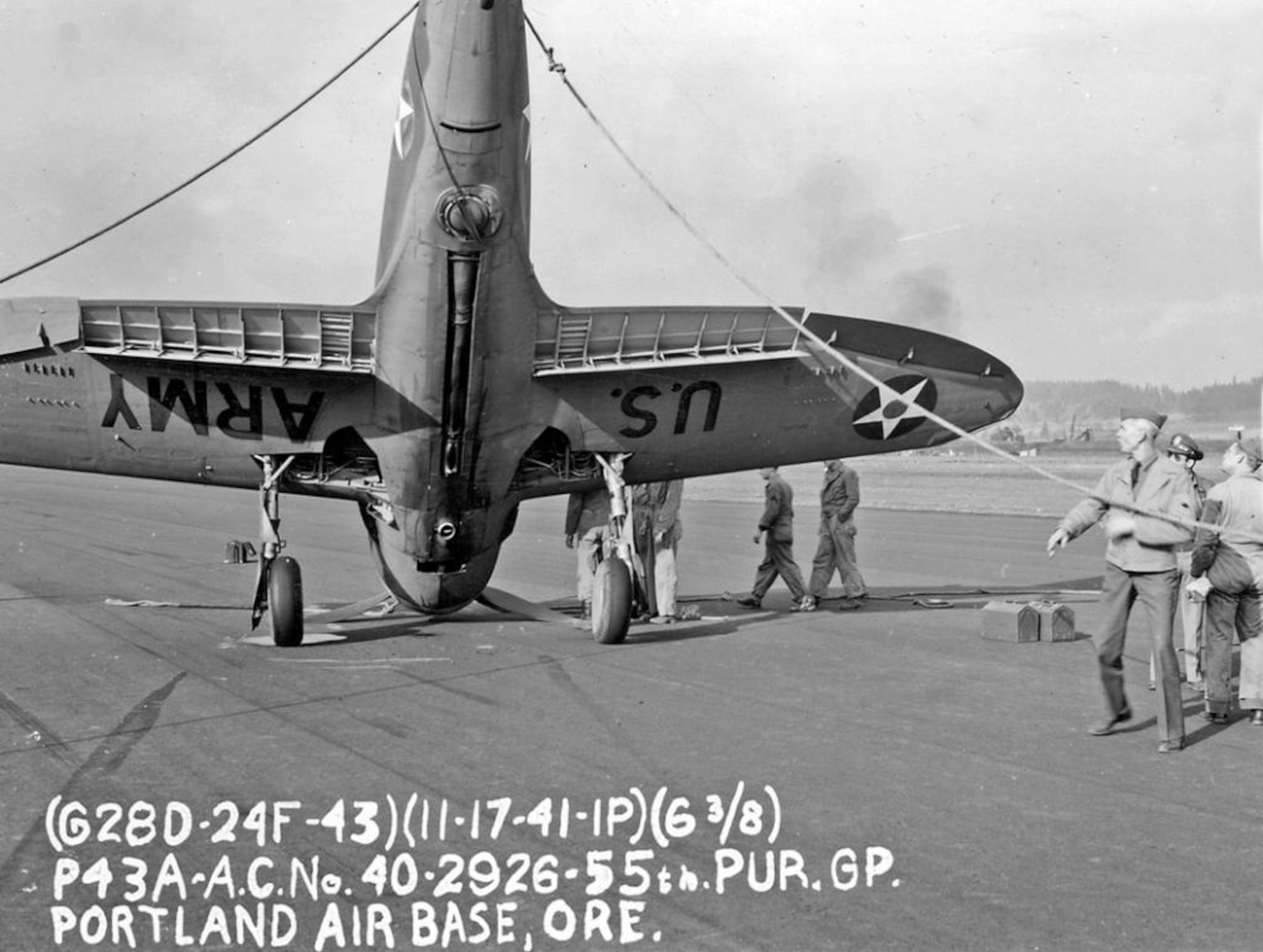 Republic P-43A Lancer serial number 40-2926 flown by 2nd Lt. Donald E. Houseal of the 54th Pursuit Squadron nosed-over on the hard surface after landing at Portland AAB, 17 November 1941.  Ground crew survey the mishap scene and determine a course of action.  Note the tool boxes at right, and an officer, perhaps the pilot, at right in sunglasses.  The long ducting on the bottom of the fuselage is part of the aircraft’s turbo-supercharger system, an engine related feature which enabled improved performance at higher altitudes. A key design feature included with some improvements in the P-43’s successor, the Republic P-47 Thunderbolt.  (Courtesy Mr. Jack Cook)