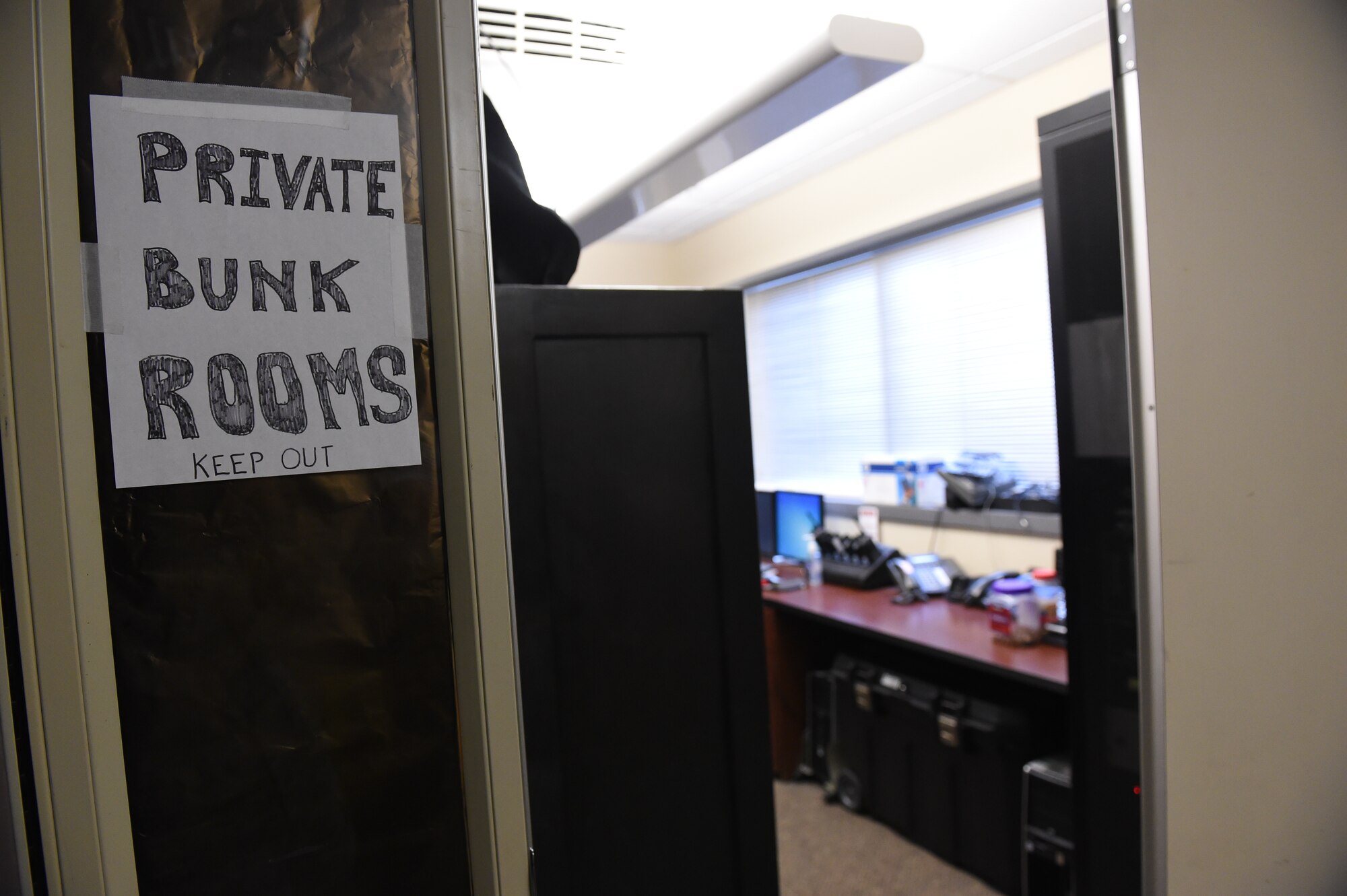 A private bunk room sign is displayed on a conference room door at the Buckley Fire and Emergency Services building Dec. 4, 2014, on Buckley Air Force Base, Colo. As part of a larger base initiative, seven new dorm rooms will be constructed onto the building to accommodate Buckley firefighters beginning January 2015. (U.S. Air Force photo by Airman 1st Class Samantha Saulsbury/Released)