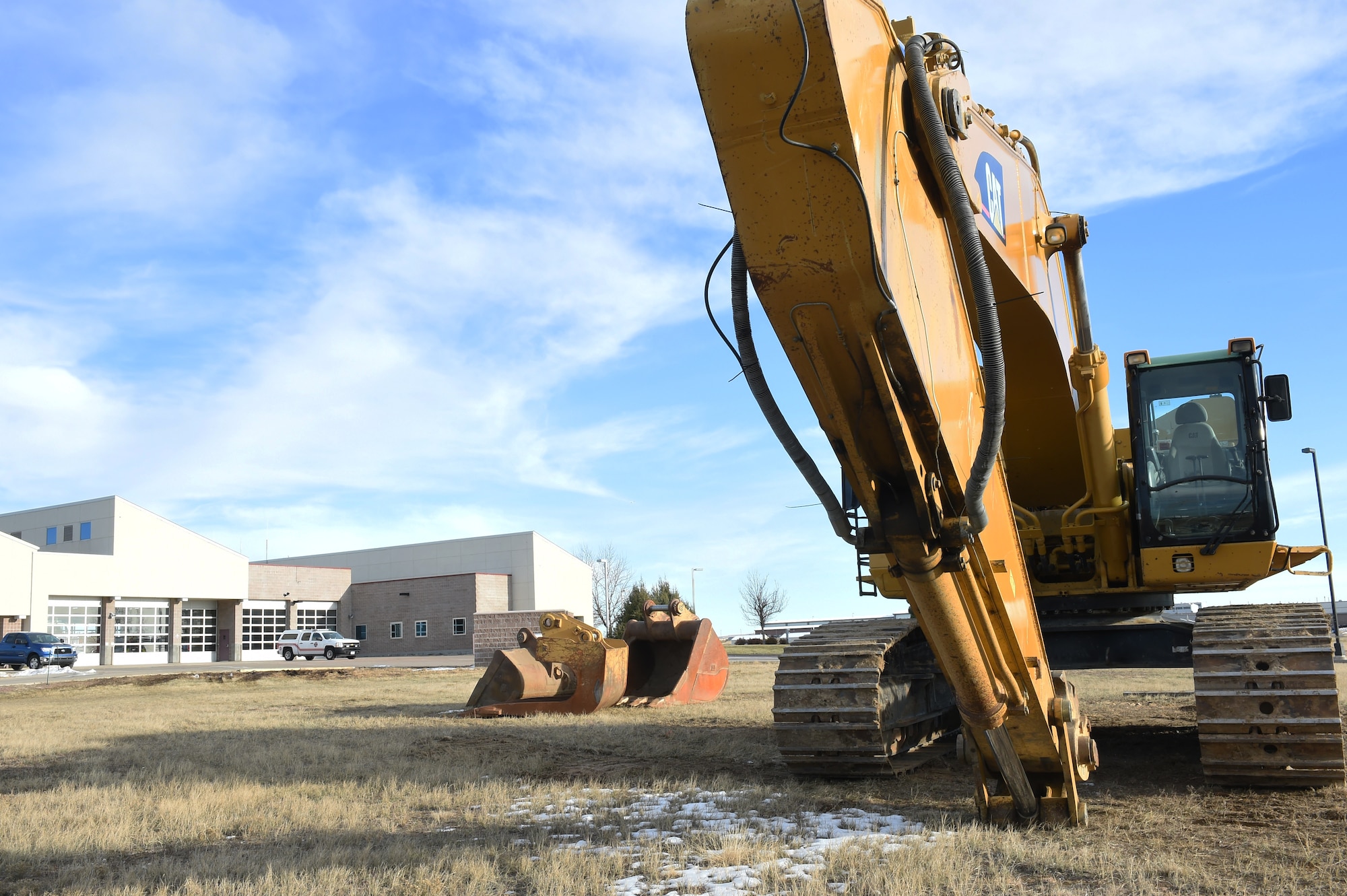 Construction equipment sits in front of the fire department Nov. 14, 2014, on Buckley Air Force Base, Colo. Many new construction projects will be occurring on Buckley, replacing and updating facilities to support service members and their families. (U.S. Air Force photo by Airman 1st Class Samantha Saulsbury/Released)