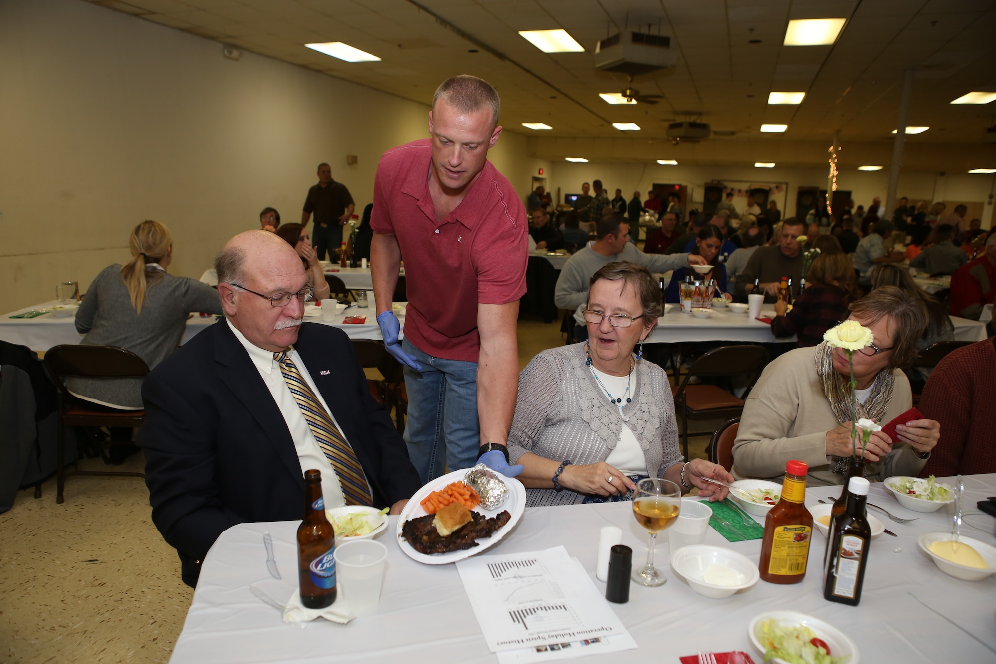 An Operation Holiday Spirit volunteer serves up a steak dinner on November 1 during the annual fundraiser at the Del City American Legion. OHS is a non-profit organization that raises support for local Reserve and Guard Airmen in need. (U.S. Air Force photo/Staff Sgt. Caleb Wanzer)