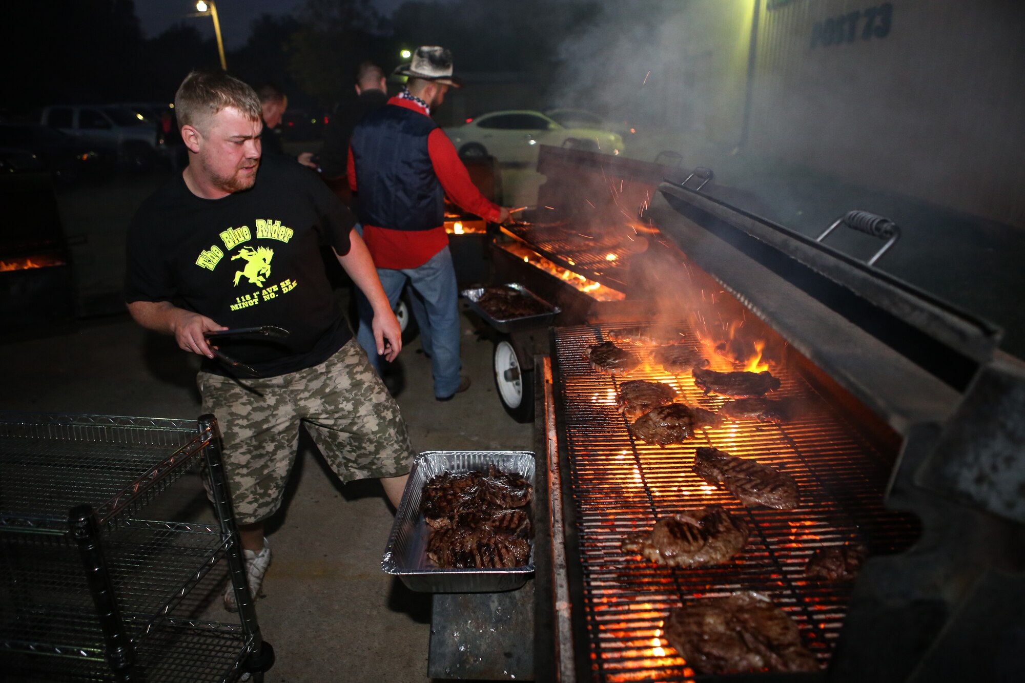 Adam Hawkins, a volunteer for Operation Holiday Spirit, watches the grill on November 1 while serving dinner to the more than 350 fundraiser attendees at the Del City American Legion. OHS is a non-profit organization that raises support for local Reserve and Guard Airmen in need. (U.S. Air Force photo/Staff Sgt. Caleb Wanzer)