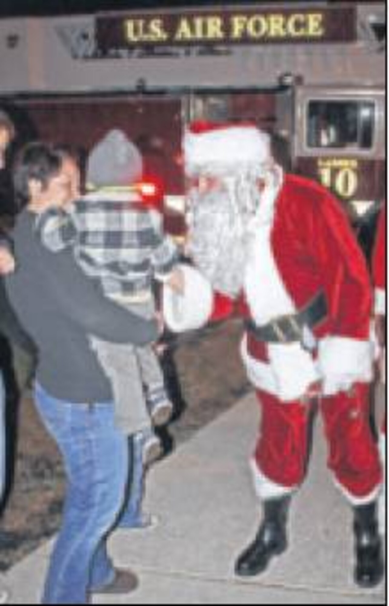 Santa Claus greets the crowd after he and Mrs. Claus arrive for the festivities on one of the base’s fire trucks. (Skywrighter photos by Tara Dixon Engel)